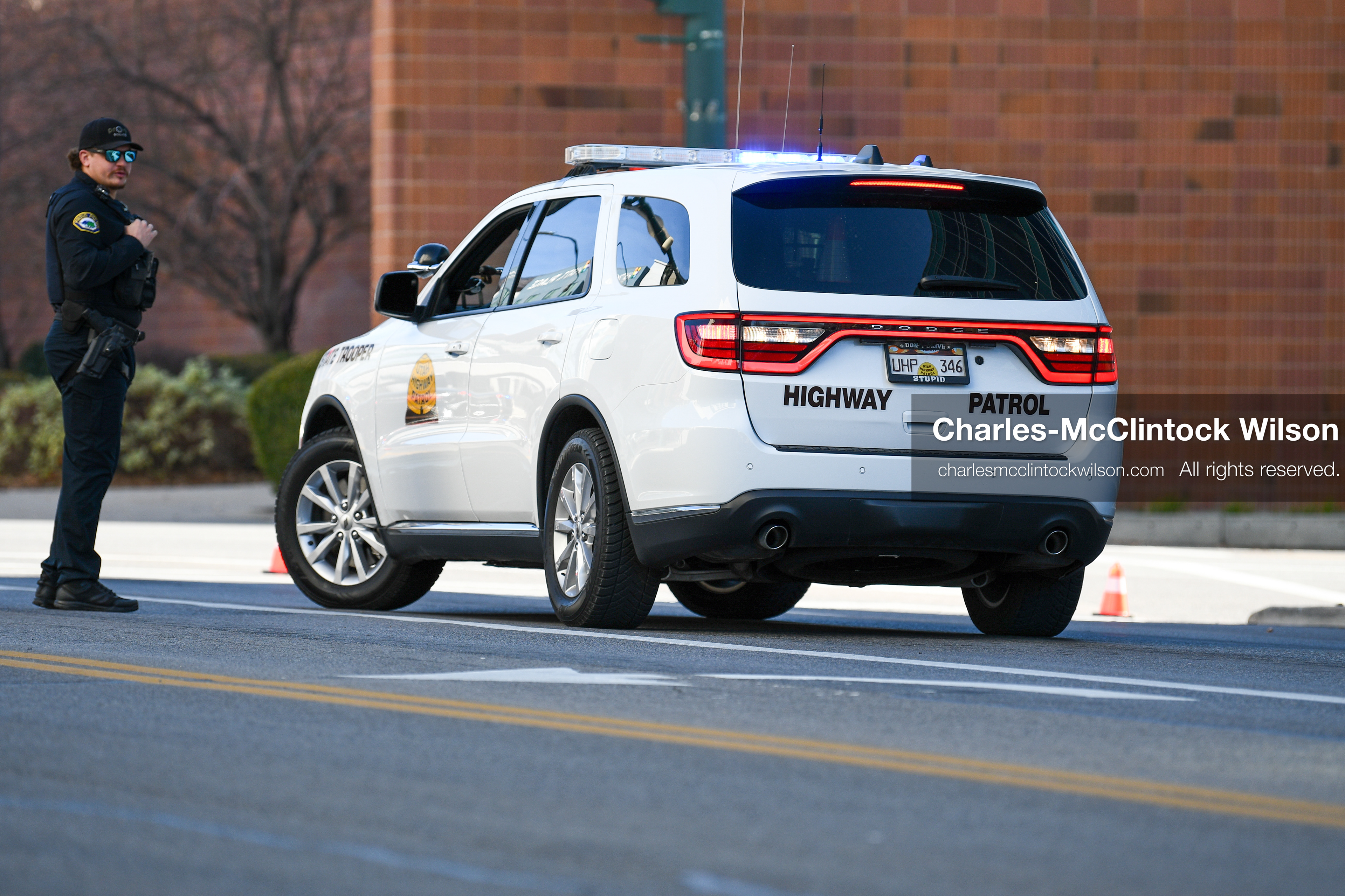 PROVO, UTAH, USA – DECEMBER 11, 2025: A Provo Police officer converses with Utah Highway Patrol officers near the Fourth District Court in Provo during the first in‑person court appearance of Tyler Robinson in the Charlie Kirk murder case. (Credit Image: © Charles‑McClintock Wilson/ZUMA Press Wire)