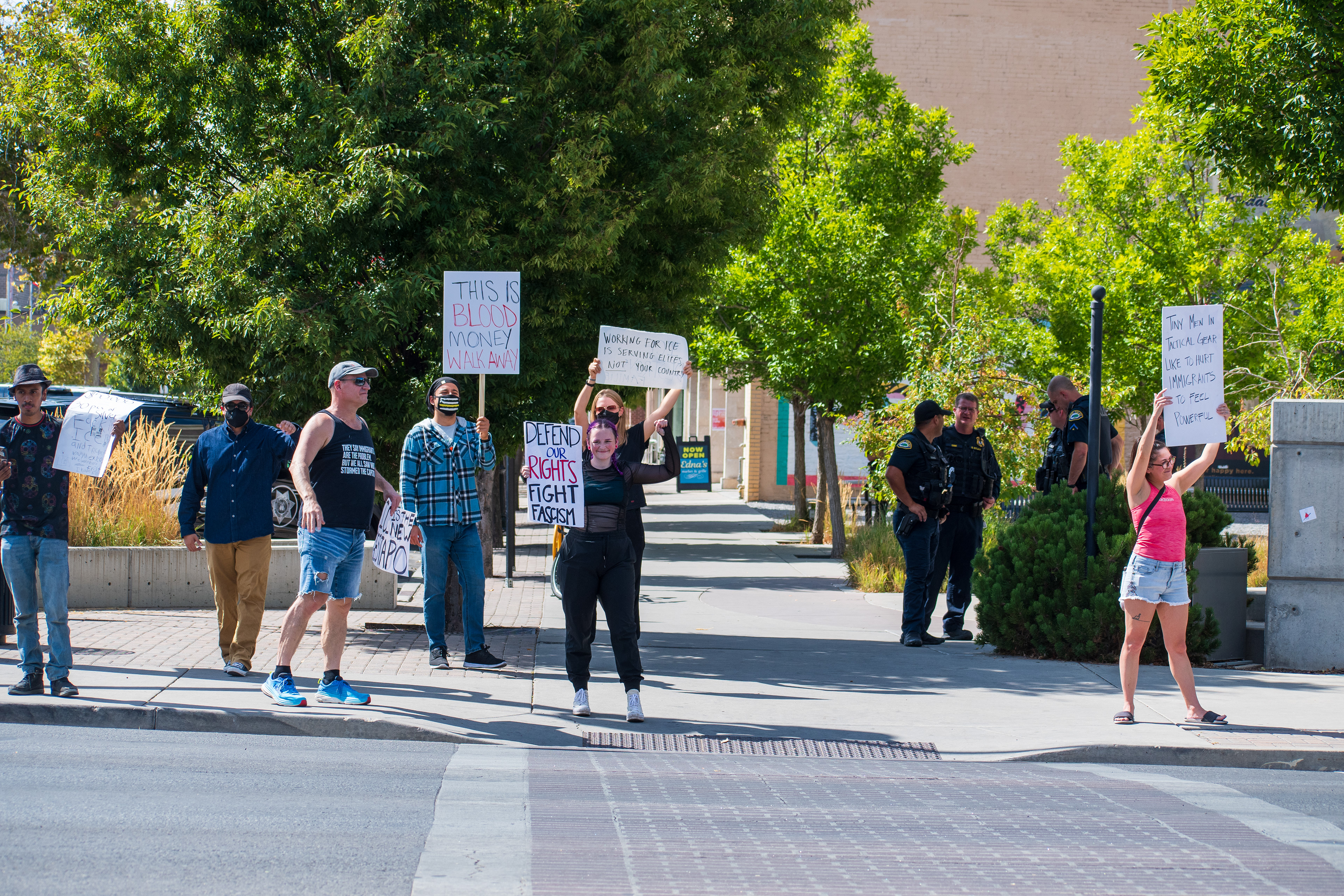 September 15, 2025 – Provo, Utah, United States: Demonstrators hold signs outside the Utah Valley Convention Center during a protest against the Department of Homeland Security career expo, voicing opposition to federal policing and immigration enforcement. Photograph by Charles‑McClintock Wilson / ZUMA Press Wire