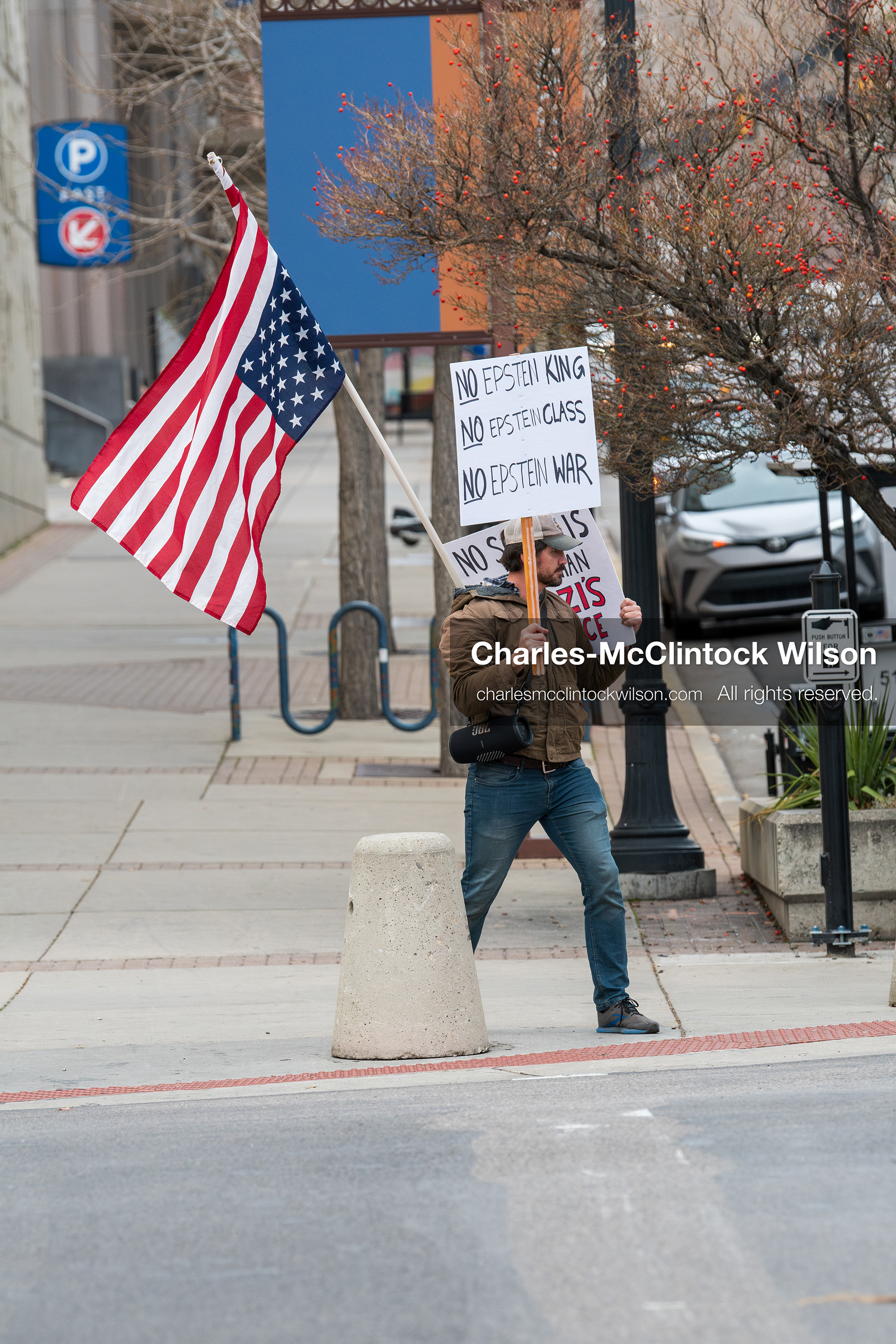 January 3, 2026, Salt Lake City, Utah, USA: A protester holds signs and an American flag during a demonstration against US action in Venezuela outside the Wallace Federal Building in Salt Lake City, Utah. The protest was part of a nationwide mobilization responding to recent military developments. (Credit Image: (c) Charles‑McClintock Wilson/ZUMA Press Wire)