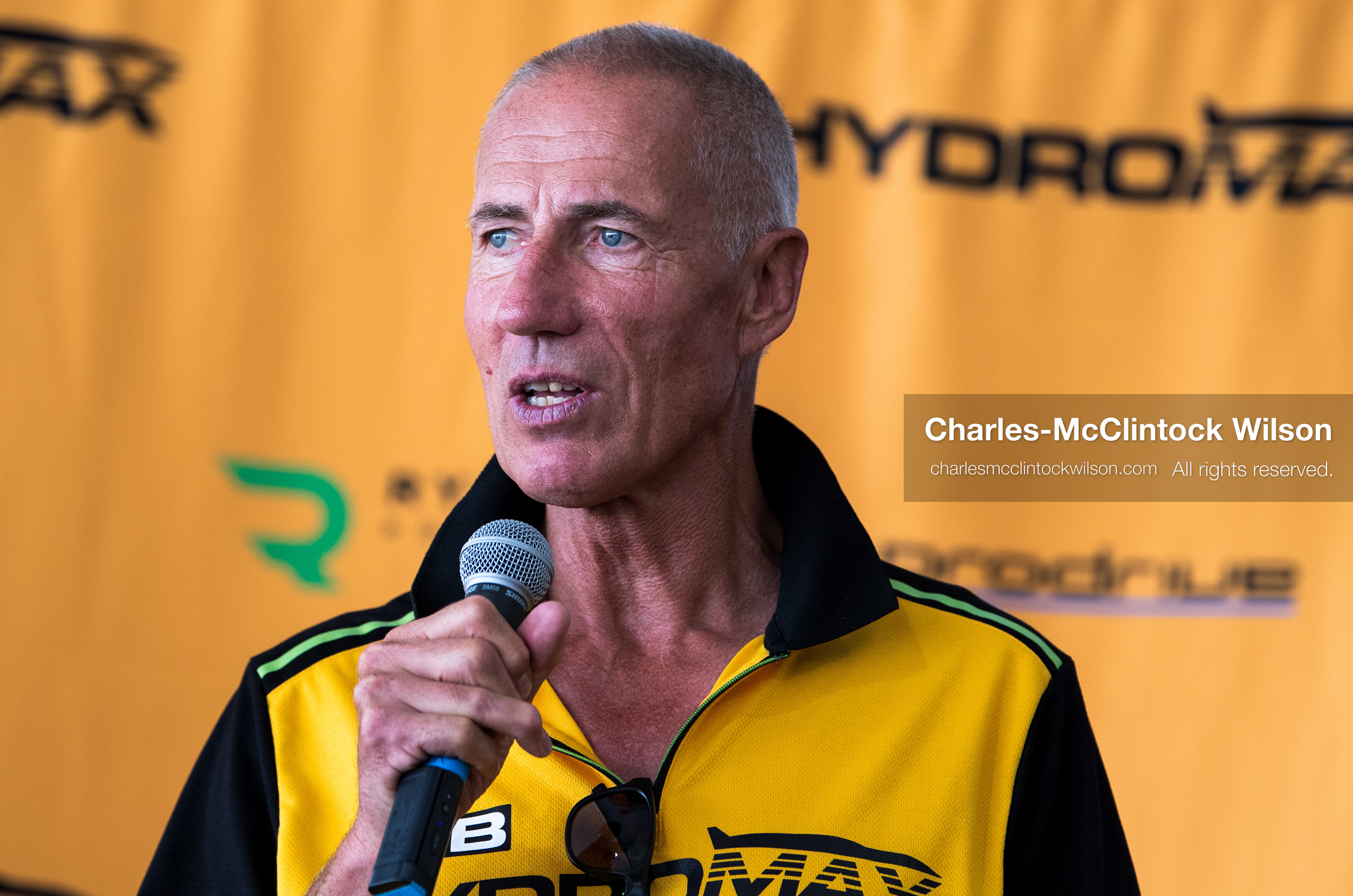British pilot Andy Green speaks into a microphone during a press conference on the Bonneville Salt Flats on Tuesday. Green steered the hydrogen-powered "JCB Hydromax" streamliner to a historic record-breaking top speed of 406.320 mph during official speed trials. (Photo by Charles-McClintock Wilson/Sipa USA)