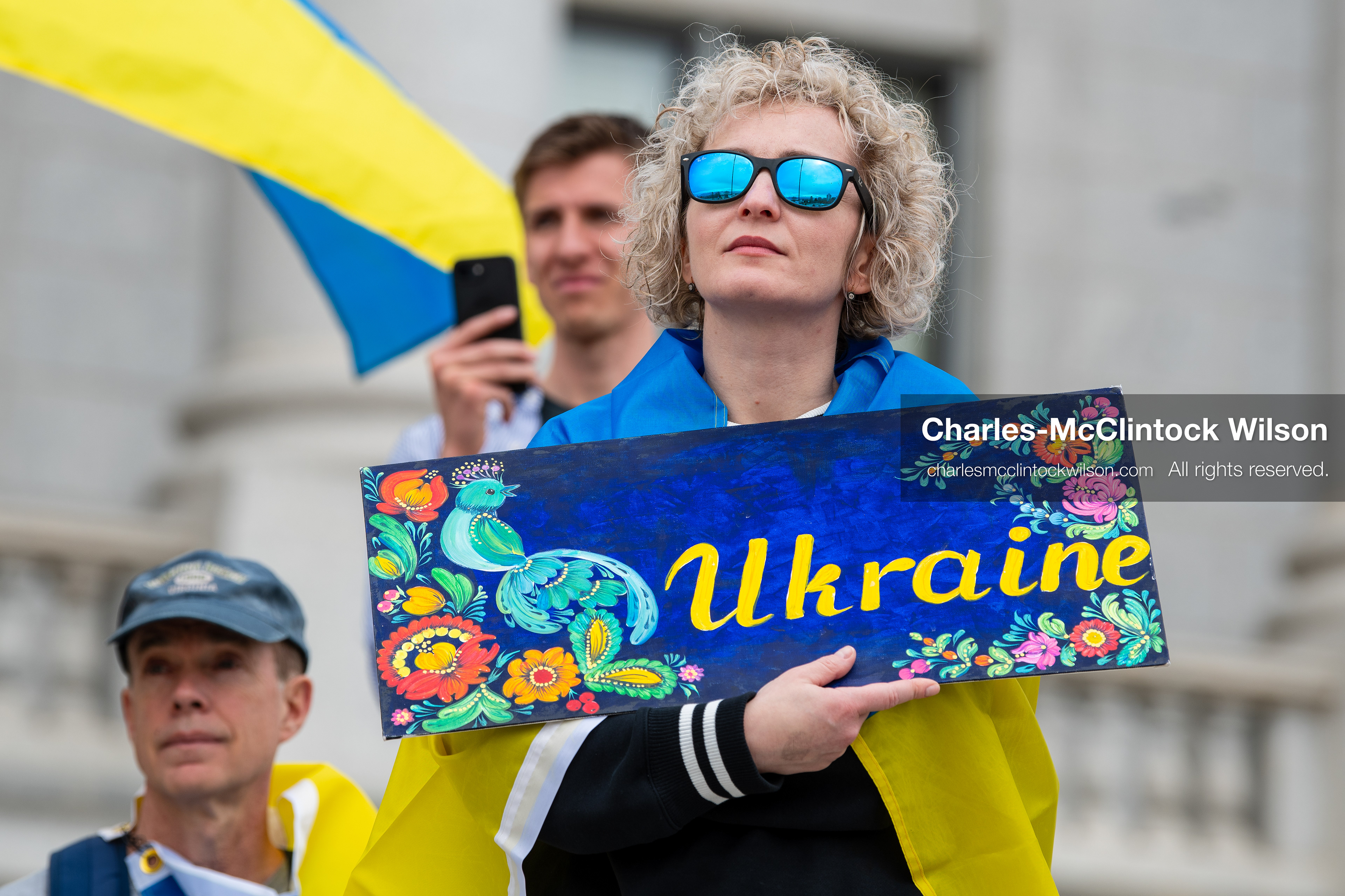 February 28, 2026, Salt Lake City, Utah, USA: A demonstrator draped in a Ukrainian flag holds a hand painted sign reading Ukraine during the Stand With Ukraine rally at the Utah State Capitol. The gathering marked the four year anniversary of the full scale Russian invasion of Ukraine and brought community members together in support of Ukrainians and local humanitarian efforts. (Credit Image: © Charles McClintock Wilson/ZUMA Press Wire)