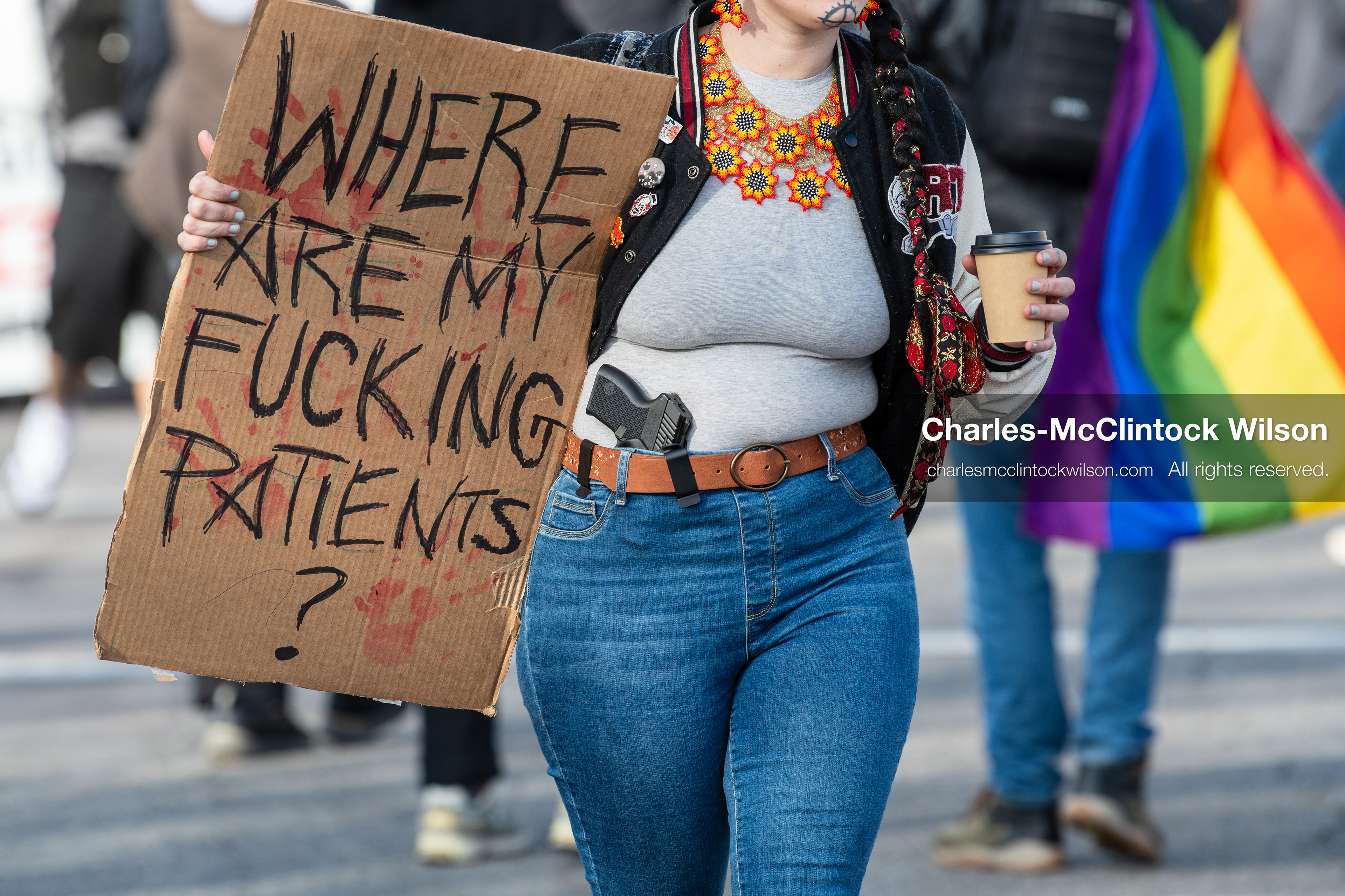 January 30, 2026, Salt Lake City, Utah, USA: A demonstrator carries a firearm positioned at her waist while holding a sign during an anti‑ICE protest in Salt Lake City, part of a nationwide response to immigration enforcement policies. (Credit Image: © Charles‑McClintock Wilson/ZUMA Press Wire)