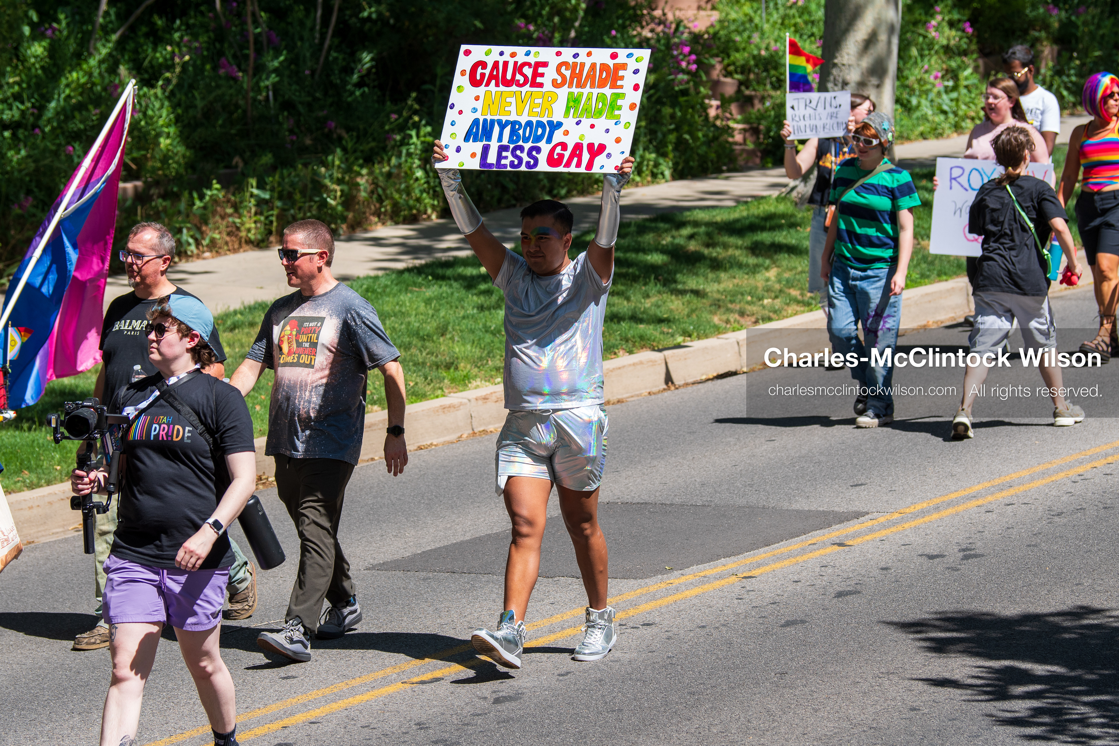June 6, 2026, Salt Lake City, Utah, USA: A participant wearing a reflective outfit holds up a sign reading ''Cause Shade Never Made Anybody Less Gay'' while walking down the street during the Utah Pride Rally and March. (Credit Image: © Charles McClintock Wilson/ZUMA Press Wire)