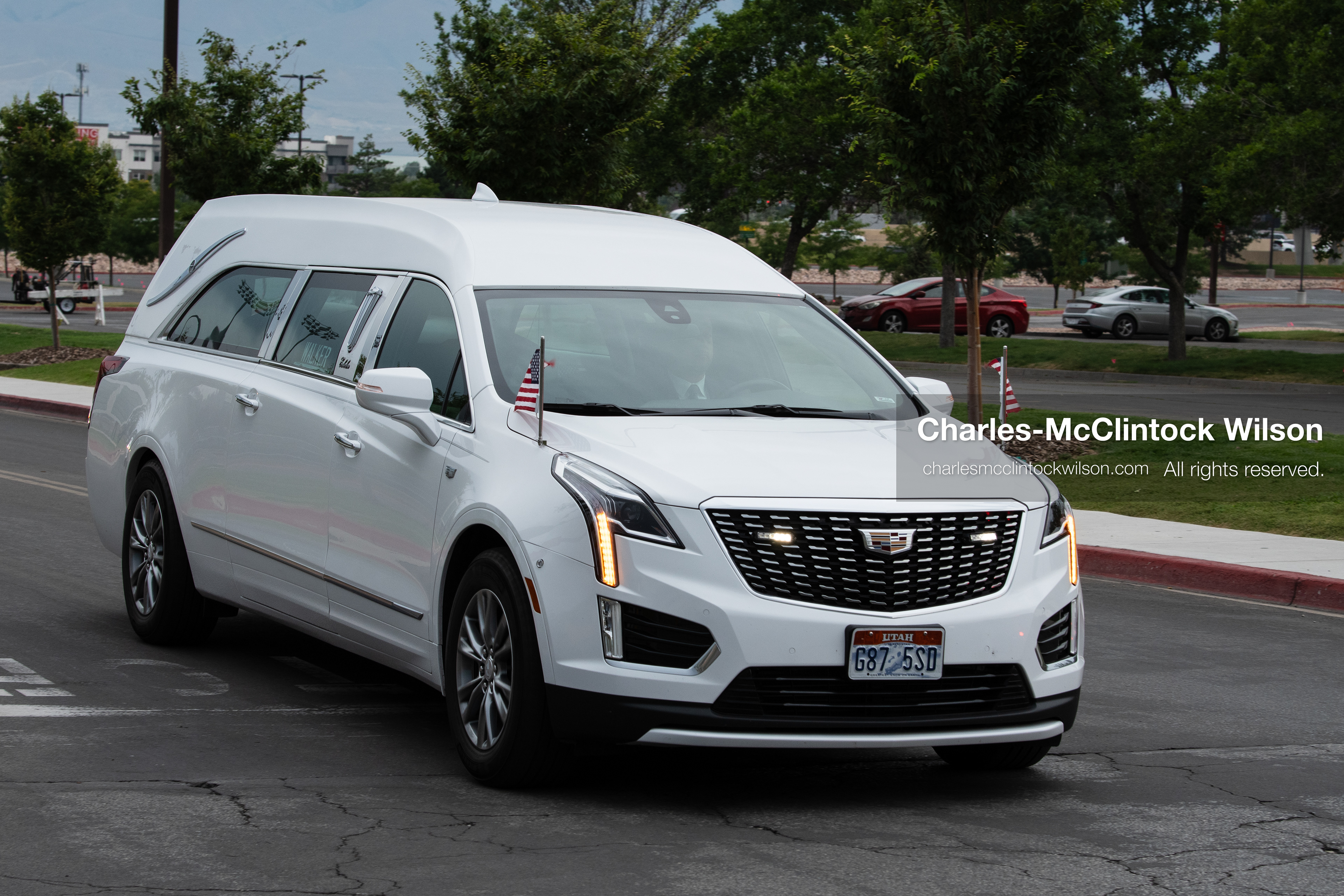 A white Cadillac hearse carrying the remains of Provo Fire Captain Spencer Long arrives at the UCCU Center at Utah Valley University in Orem, Utah, on Wednesday, July 29, 2026. The 17-year veteran of the fire department, along with his wife and three sons, lost their lives after flash floods struck their campsite in Wayne County.(Photo by Charles-McClintock Wilson/Sipa USA)