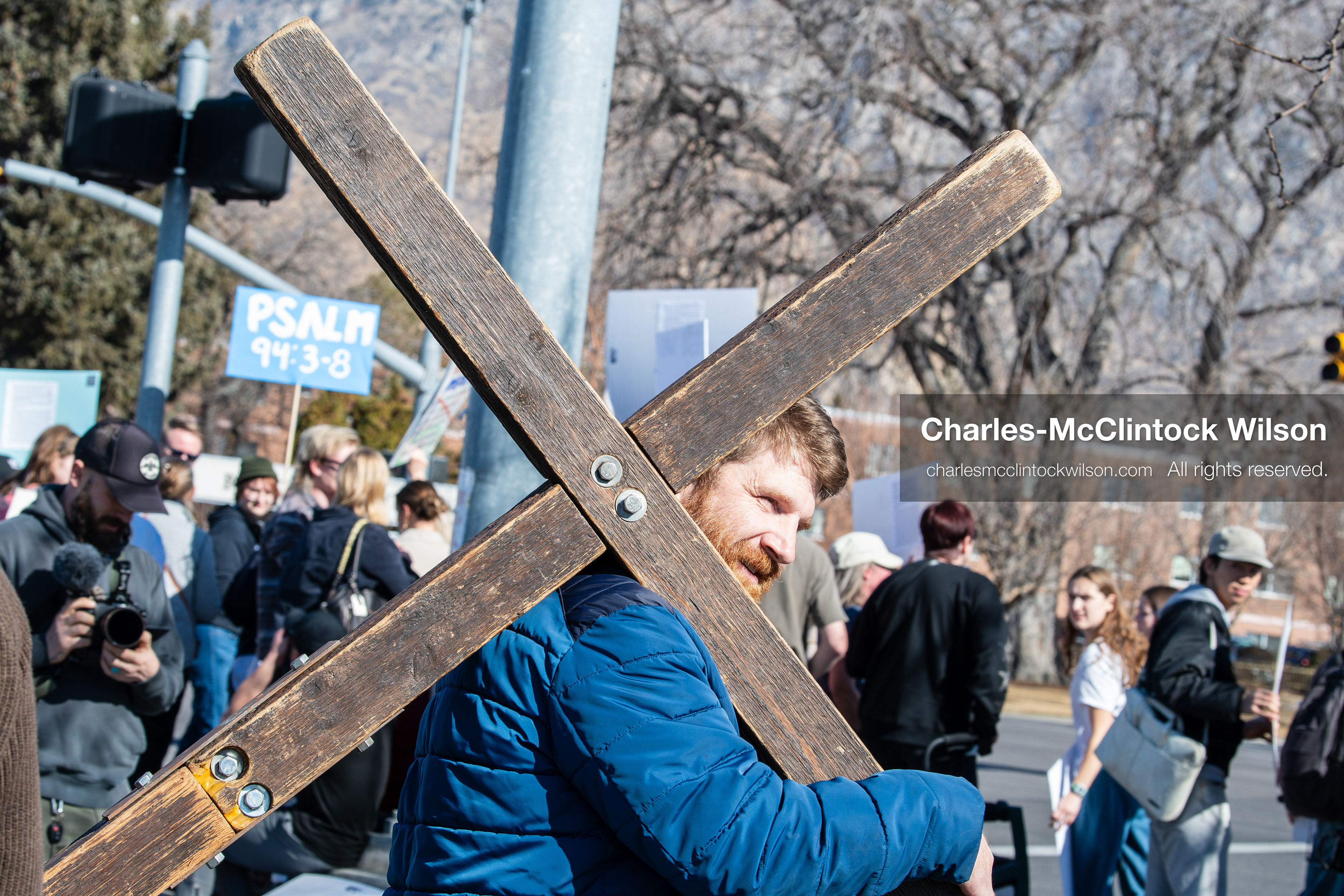 February 5, 2026, Provo, Utah, USA: A man carries a wooden cross while walking near Brigham Young University in Provo during a protest opposing the presence of US Customs and Border Protection recruiters at a career fair held on the BYU campus. (Credit Image: © Charles McClintock Wilson/ZUMA Press Wire)