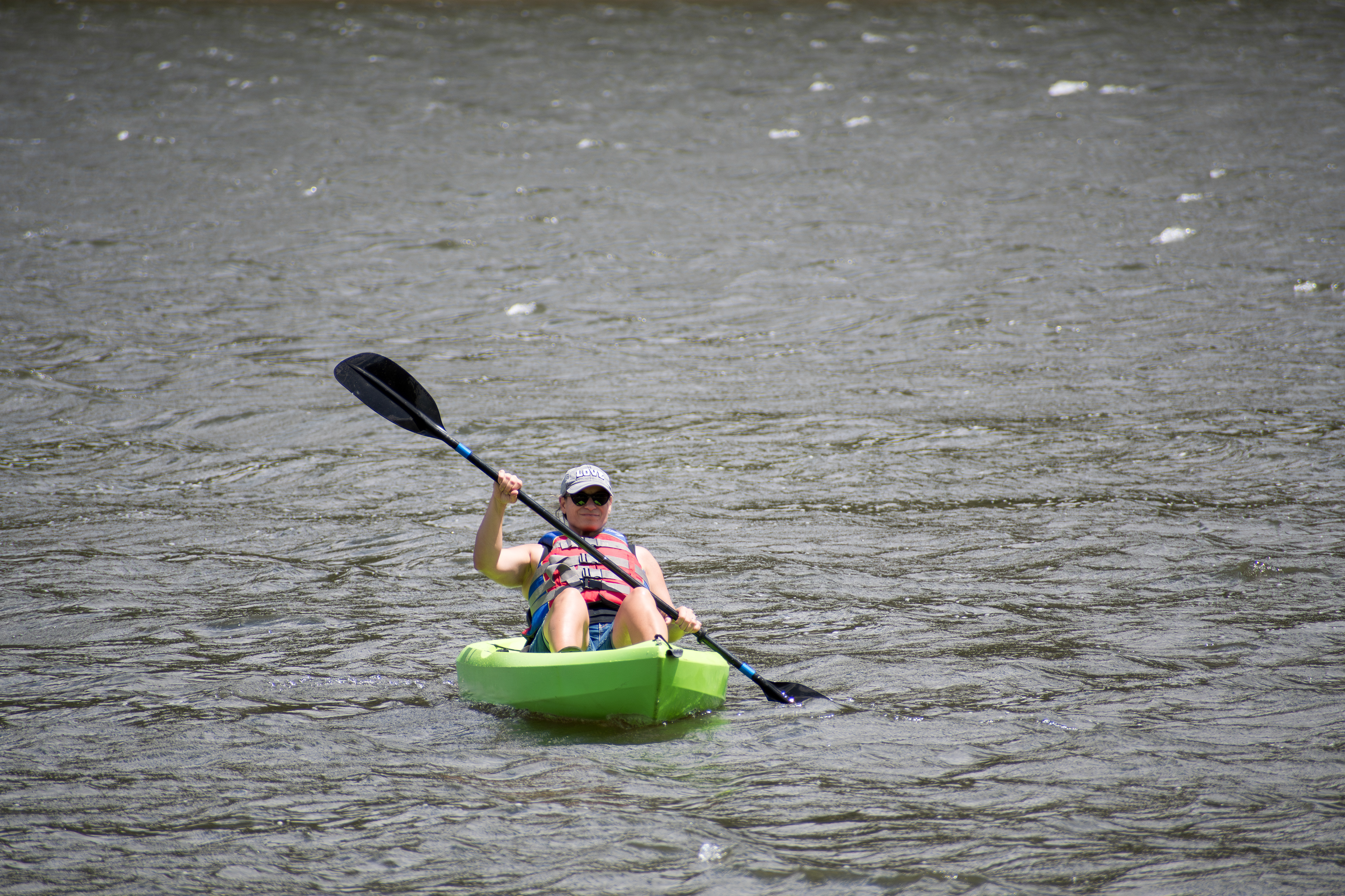 Summit County, Utah – July 20, 2025: A woman paddles a kayak across the calm waters of Smith and Morehouse Reservoir during a peaceful summer outing.