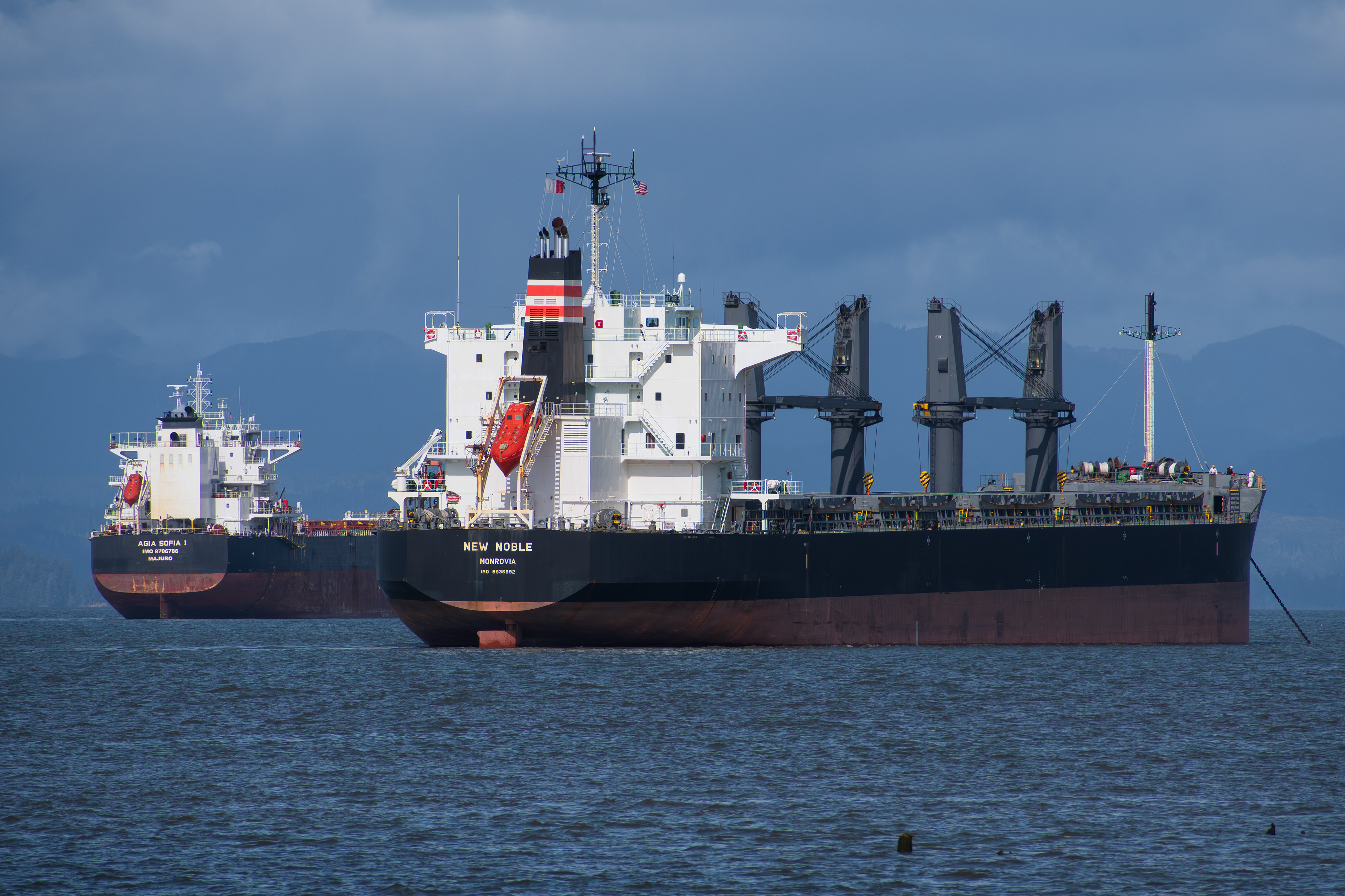 ASTORIA, OR, USA – APRIL 10: Various cargo ships are seen docked along the Columbia River near Astoria, Oregon, United States on April 10, 2025.