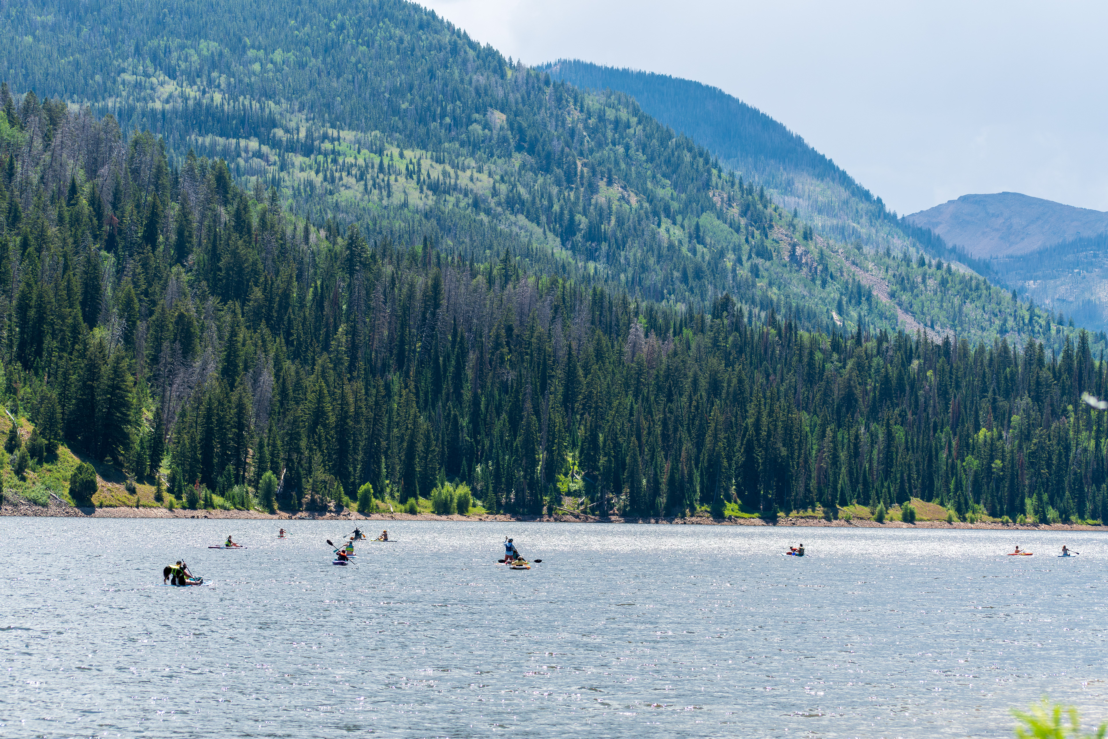 Summit County, Utah – July 20, 2025: People enjoy outdoor recreation on kayaks and paddleboards at Smith and Morehouse Reservoir.