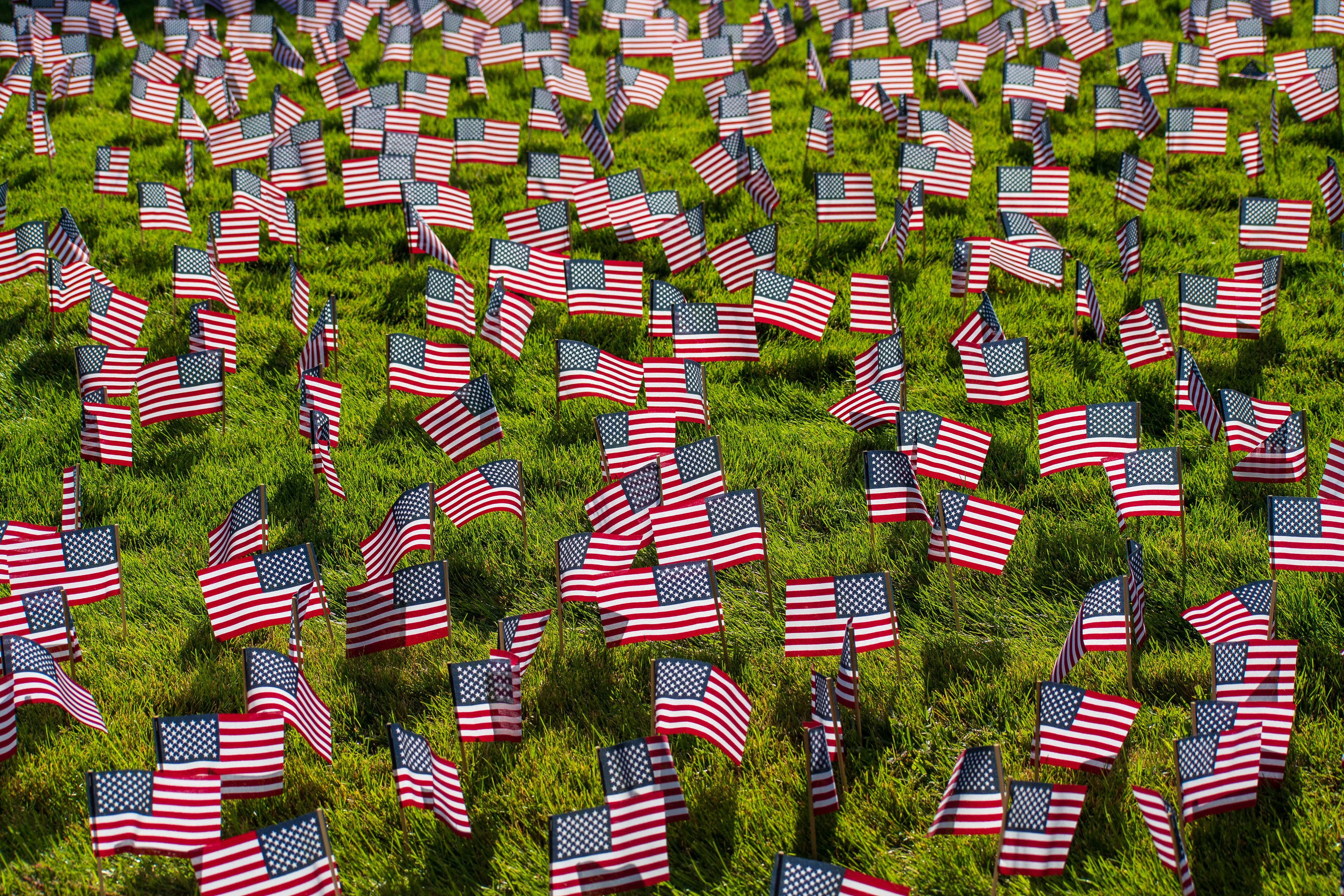 OREM, UTAH – SEPTEMBER 10, 2025: Hundreds of small American flags are planted in formation across the lawn at Utah Valley University during the opening stop of the American Comeback Tour. The installation reflects a moment of visual solemnity, symbolic presence, and commemorative clarity. The image captures the spatial rhythm and emotional resonance of a public gathering shaped by remembrance and civic engagement. © Charles-McClintock Wilson / ZUMA Press