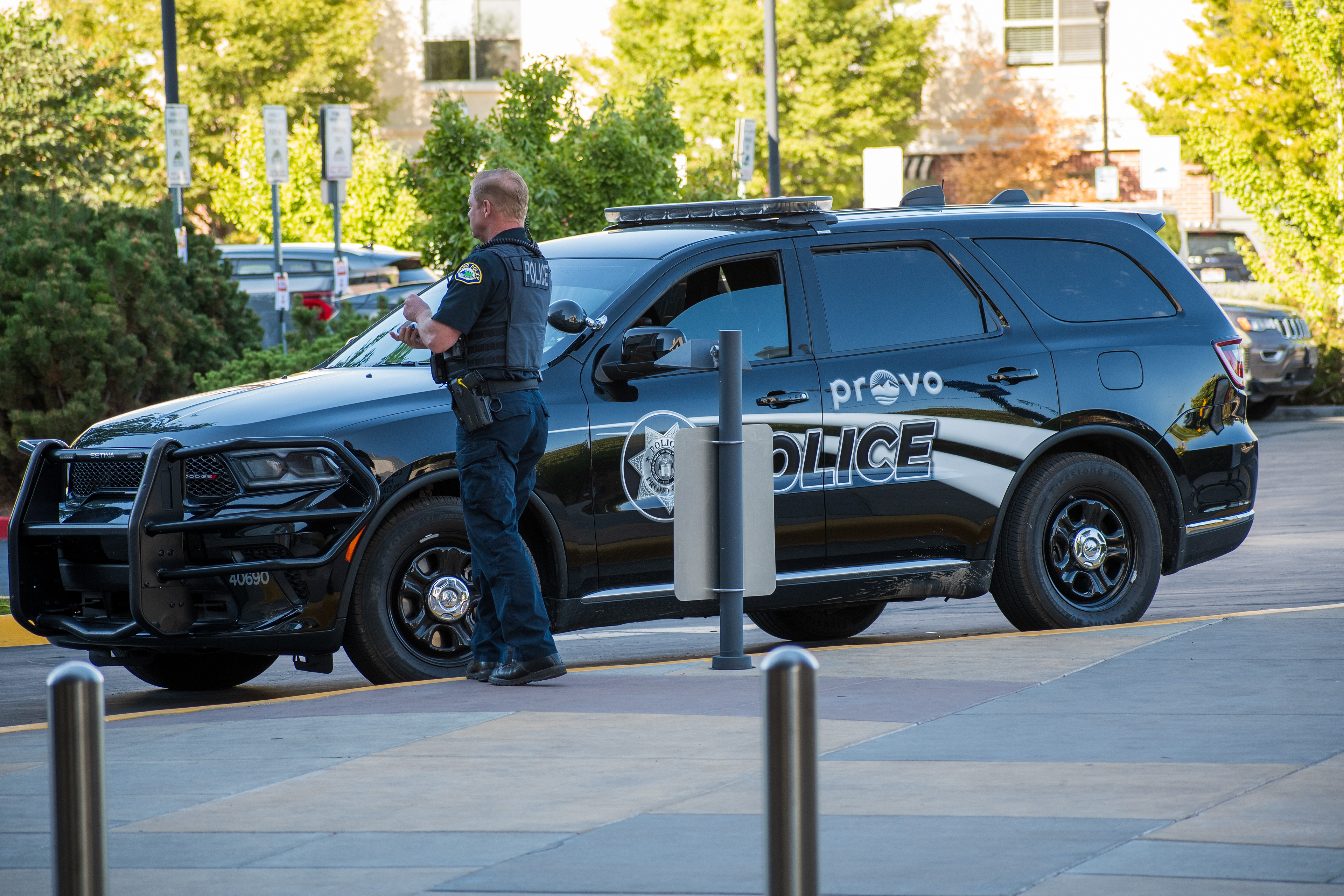 September 15, 2025 – Provo, Utah, United States: A Provo Police Department officer stands beside a marked patrol vehicle near the Utah Valley Convention Center during a Department of Homeland Security career expo focused on recruiting law enforcement and security personnel. Photograph by Charles‑McClintock Wilson / ZUMA Press Wire