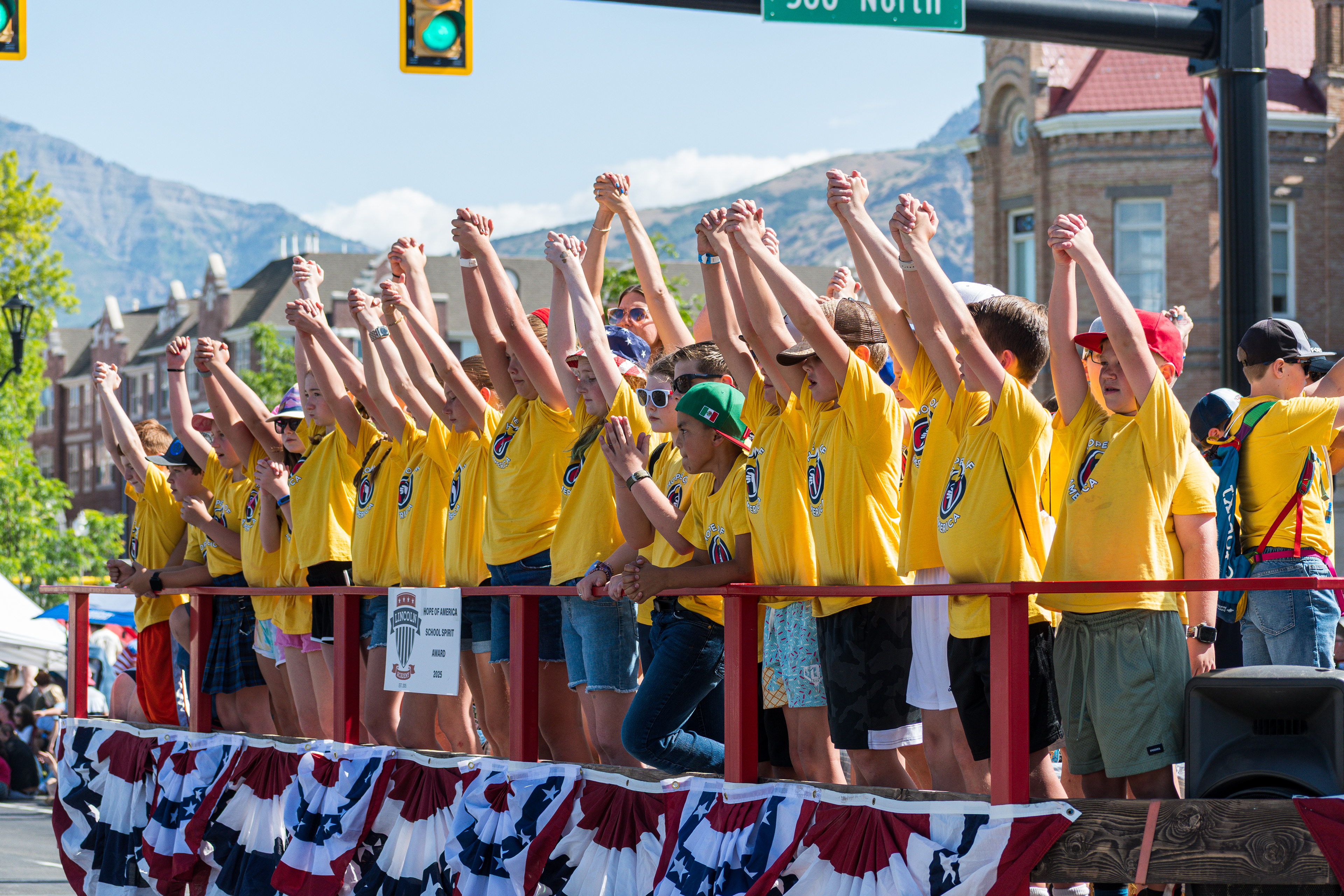 Provo, Utah – July 4, 2025: Children sit on a decorated float being pulled along the parade route during the Freedom Festival Grand Parade in downtown Provo.