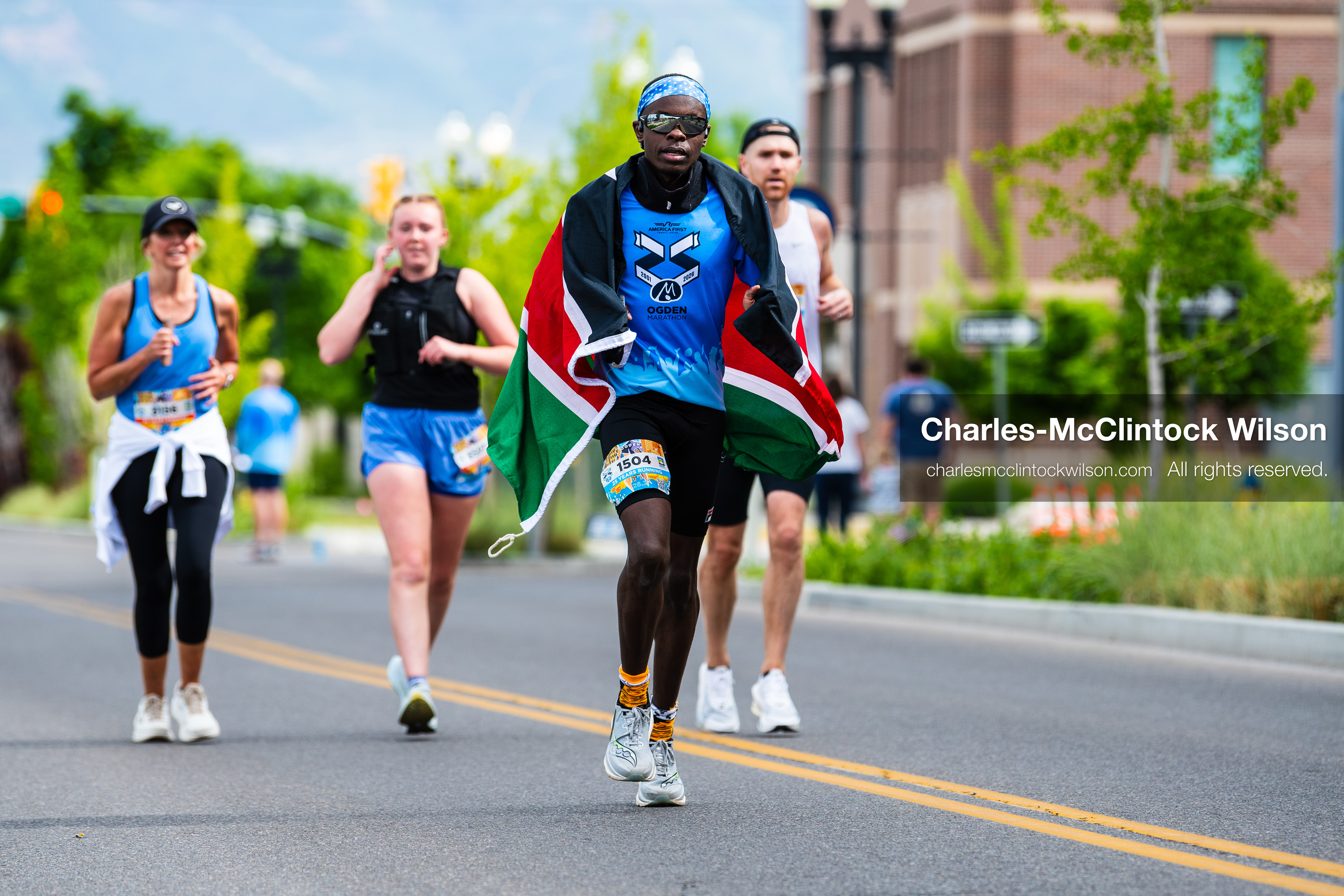 May 16, 2026, Ogden, Utah, USA: A runner draped in the Kenyan flag competes in the 25th Annual America First Ogden Marathon in Ogden, Utah, on Saturday, May 16, 2026. The event drew thousands of participants and spectators for the milestone 25th running of the marathon. (Credit Image: © Charles-McClintock Wilson/ZUMA Press Wire)