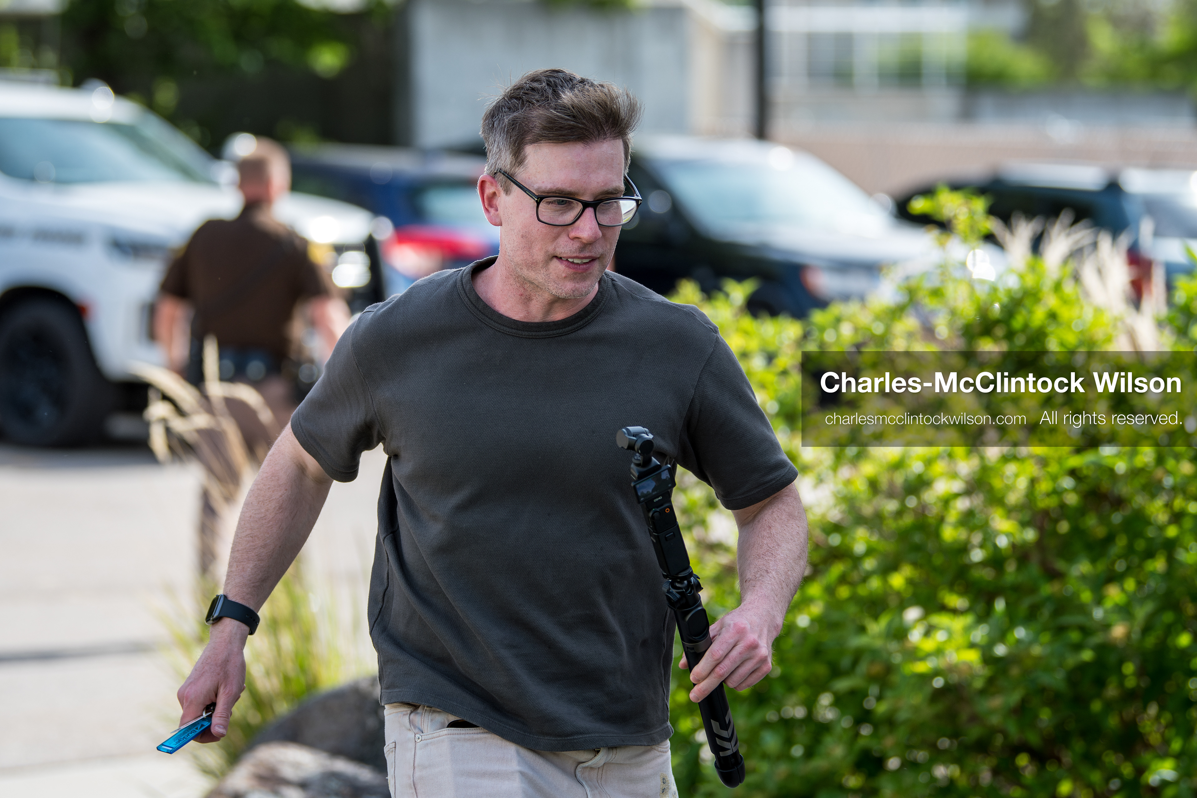 May 13, 2026, Brigham City, Utah, USA: US political satirist and digital creator WALTER MASTERSON walks outside the Box Elder County Justice Courthouse in Brigham City, Utah, carrying video equipment during a gathering over the proposed data‑center project backed by businessman Kevin O’Leary, which has drawn public concern over water use, power demand, and transparency. (Credit Image: © Charles‑McClintock Wilson/ZUMA Press Wire)