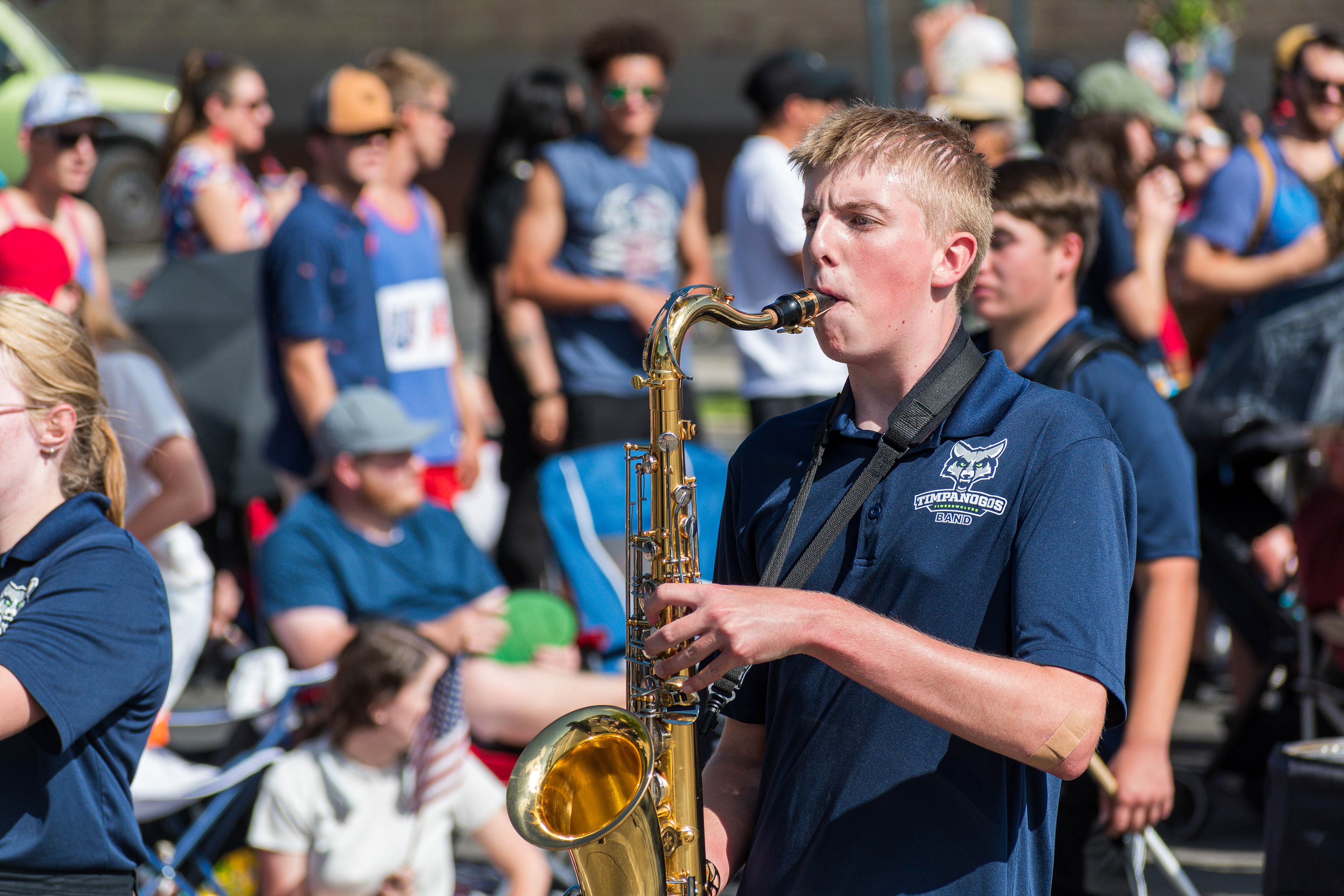 Provo, Utah – July 4, 2025: A boy plays the saxophone while participating in the Freedom Festival Grand Parade in downtown Provo.