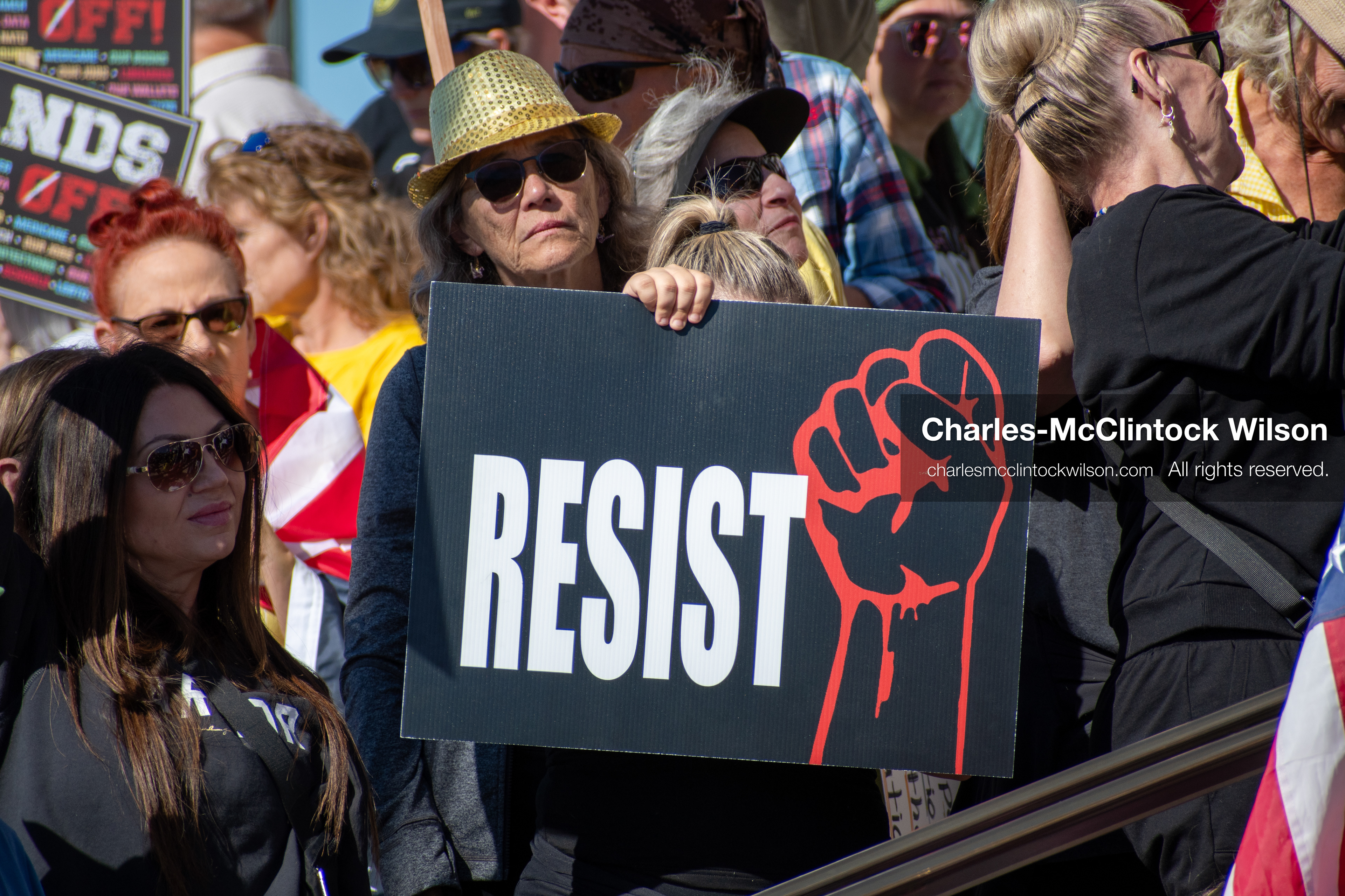 October 18, 2025, Salt Lake City, Utah, USA: A demonstrator raises a placard during a "No Kings" protest held at the Utah State Capitol. Other participants and signs are visible in the background during the public gathering.