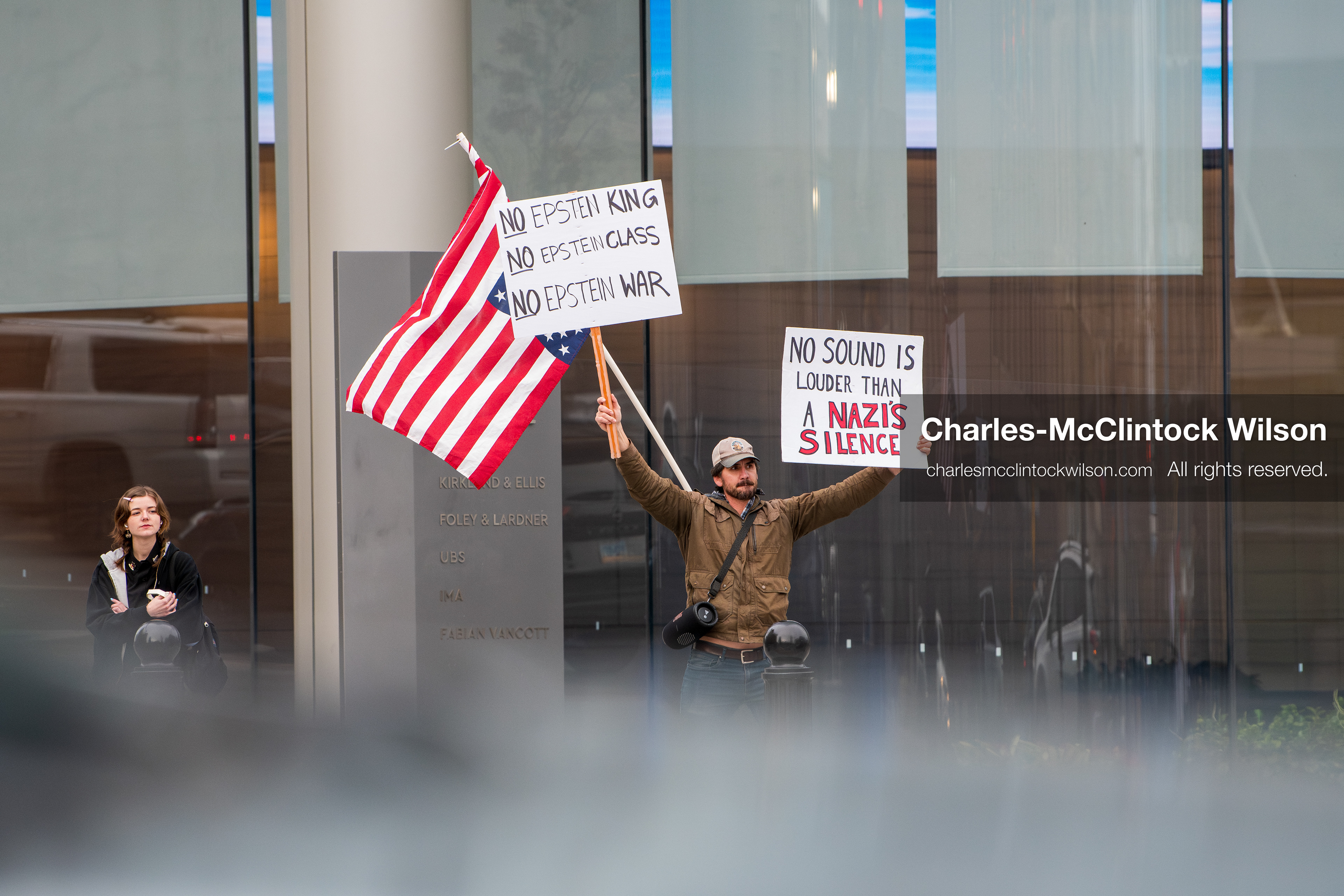 January 3, 2026, Salt Lake City, Utah, USA: A protester holds signs and an American flag during a demonstration against US action in Venezuela outside the Wallace Federal Building in Salt Lake City, Utah. The protest was part of a nationwide mobilization responding to recent military developments. (Credit Image: (c) Charles‑McClintock Wilson/ZUMA Press Wire)