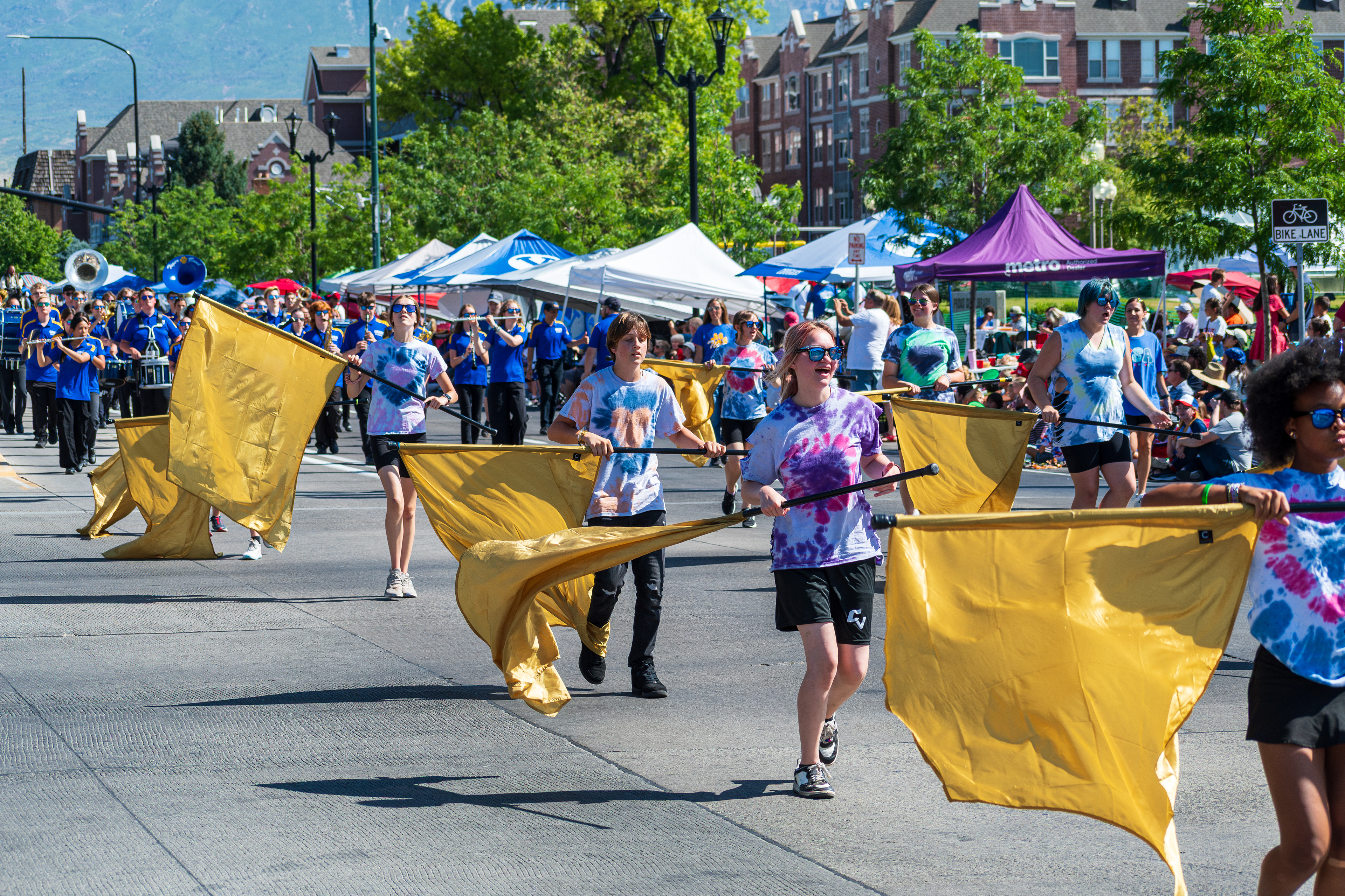 Provo, Utah – July 4, 2025: Young performers wave flags in a choreographed routine during the Freedom Festival Grand Parade, adding color and energy to the Independence Day celebration.