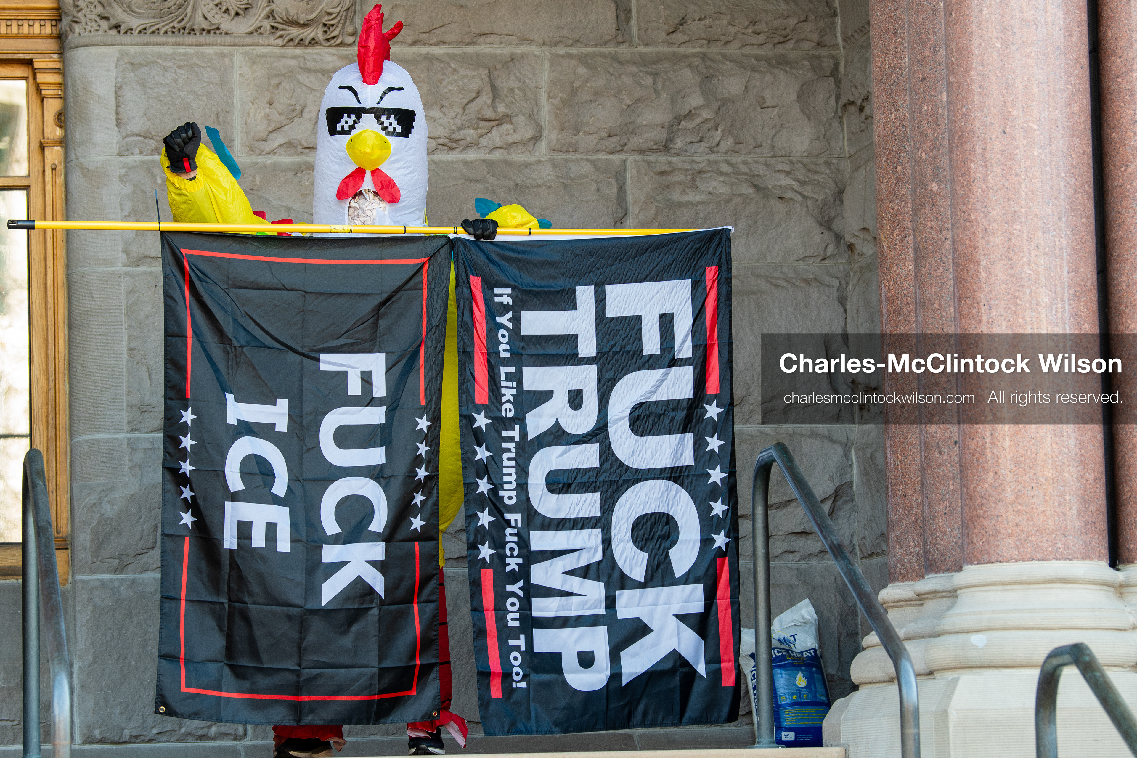 Salt Lake City, Utah, January 10, 2026: A protester wearing a chicken costume holds flags with anti‑ICE and anti‑Trump messaging during the ICE Out for Good protest at Washington Square Park, a demonstration calling for justice for Renee Nicole Good. (Credit Image: © Charles‑McClintock Wilson/ZUMA Press Wire)