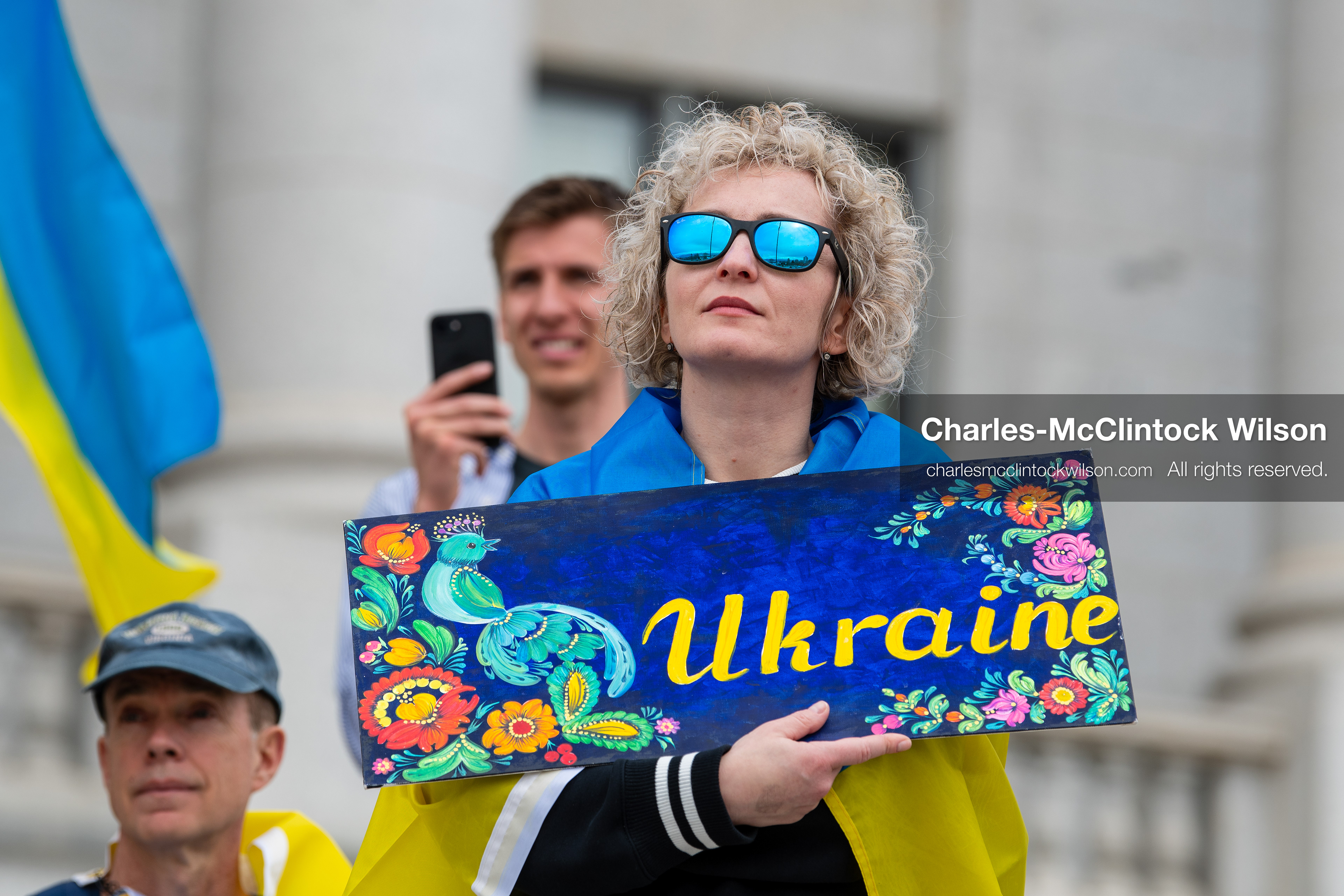 February 28, 2026, Salt Lake City, Utah, USA: A demonstrator draped in a Ukrainian flag holds a hand painted sign reading Ukraine during the Stand With Ukraine rally at the Utah State Capitol. The gathering marked the four year anniversary of the full scale Russian invasion of Ukraine and brought community members together in support of Ukrainians and local humanitarian efforts. (Credit Image: © Charles McClintock Wilson/ZUMA Press Wire)