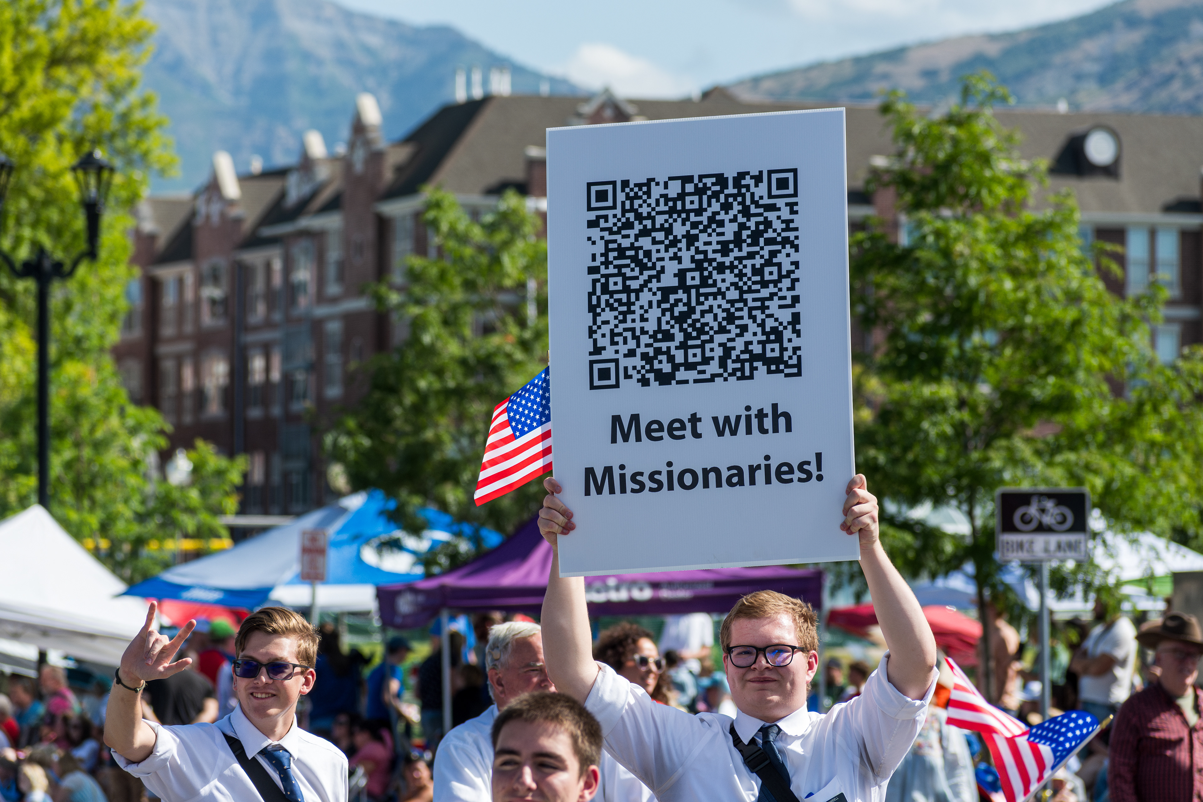 Provo, Utah - July 4, 2025: Members of The Church of Jesus Christ of Latter-day Saints march with U.S. flags and faith signs during the Freedom Festival Grand Parade in downtown Provo.