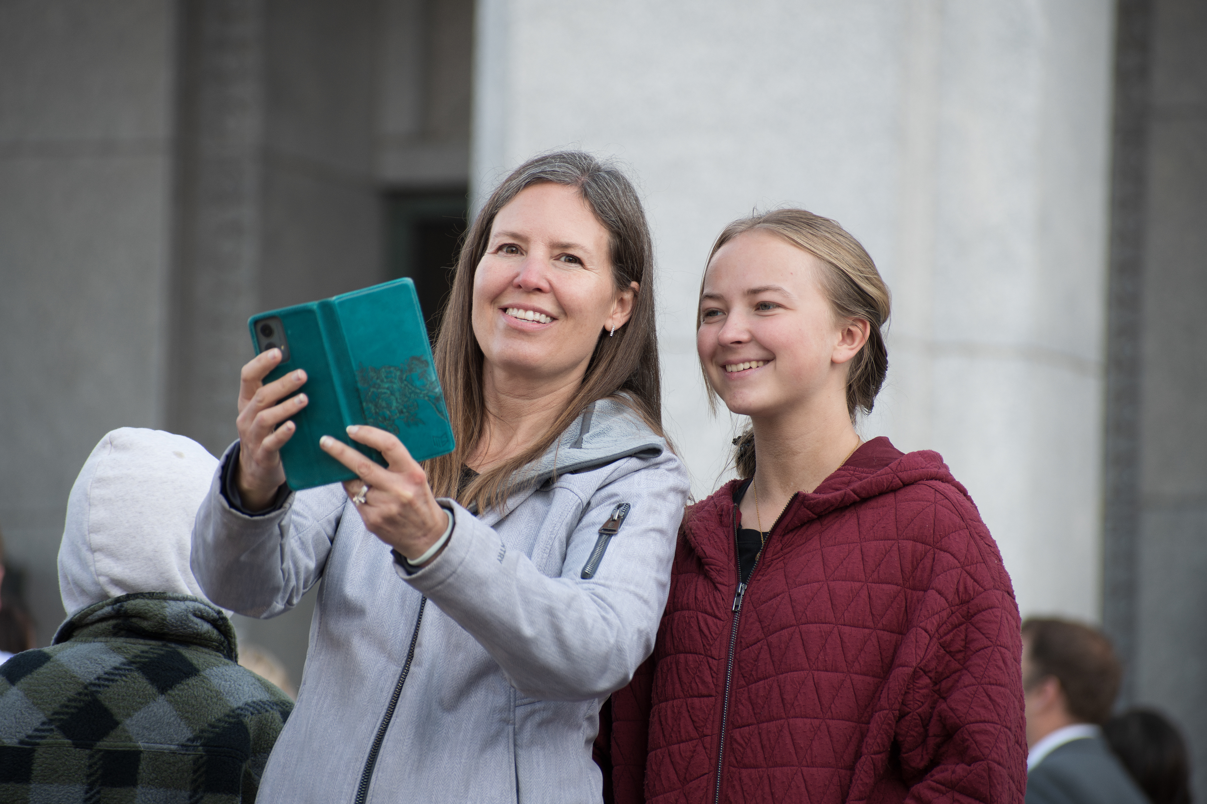 October 6, 2025, Salt Lake City, Utah, USA: Two attendees take a selfie outside the Conference Center during the public viewing for Russell M. Nelson, the 17th president of the Church of Jesus Christ of Latter-day Saints. Nelson died at his home in Salt Lake City, Utah, on September 27, 2025, at the age of 101. (Credit Image: © Charles-McClintock Wilson/ZUMA Press Wire)