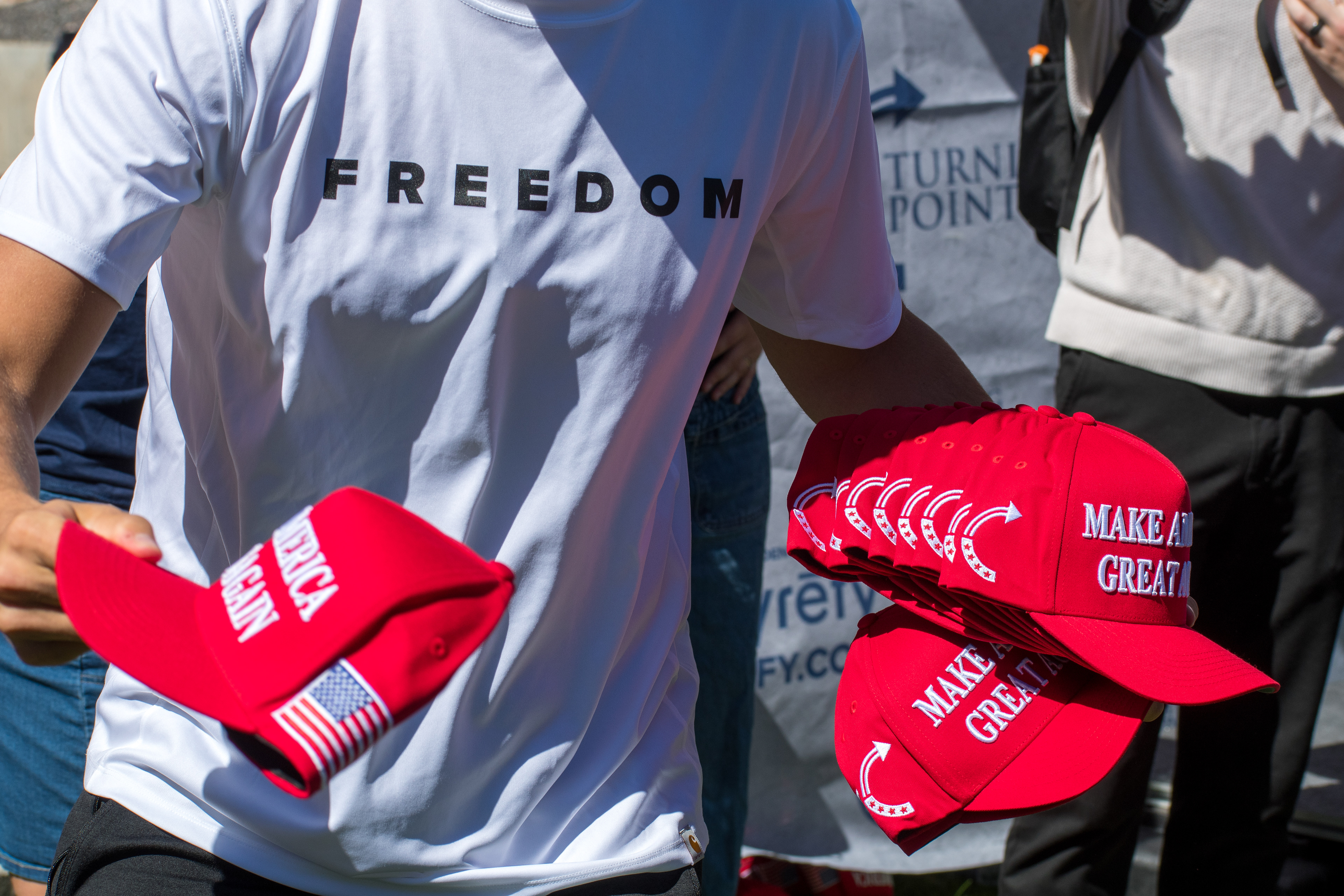 OREM, UTAH – SEPTEMBER 10, 2025: Charlie Kirk speaks with attendees during a public event at Utah Valley University. Positioned near a promotional booth and surrounded by supporters, Kirk appears engaged and expressive in one of his final public moments. The image reflects the atmosphere of direct outreach and energized dialogue that defined the gathering. © Charles-McClintock Wilson / ZUMA Press