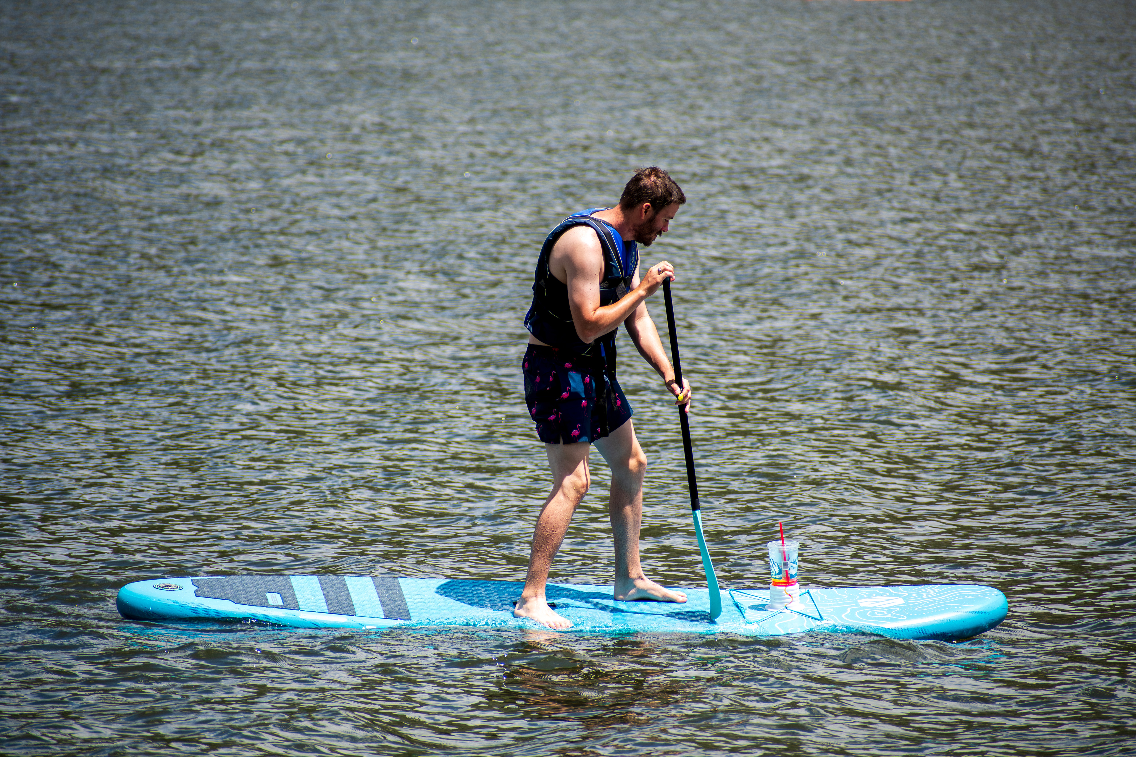 Summit County, Utah – July 20, 2025: A man paddleboards across the water at Smith and Morehouse Reservoir. 