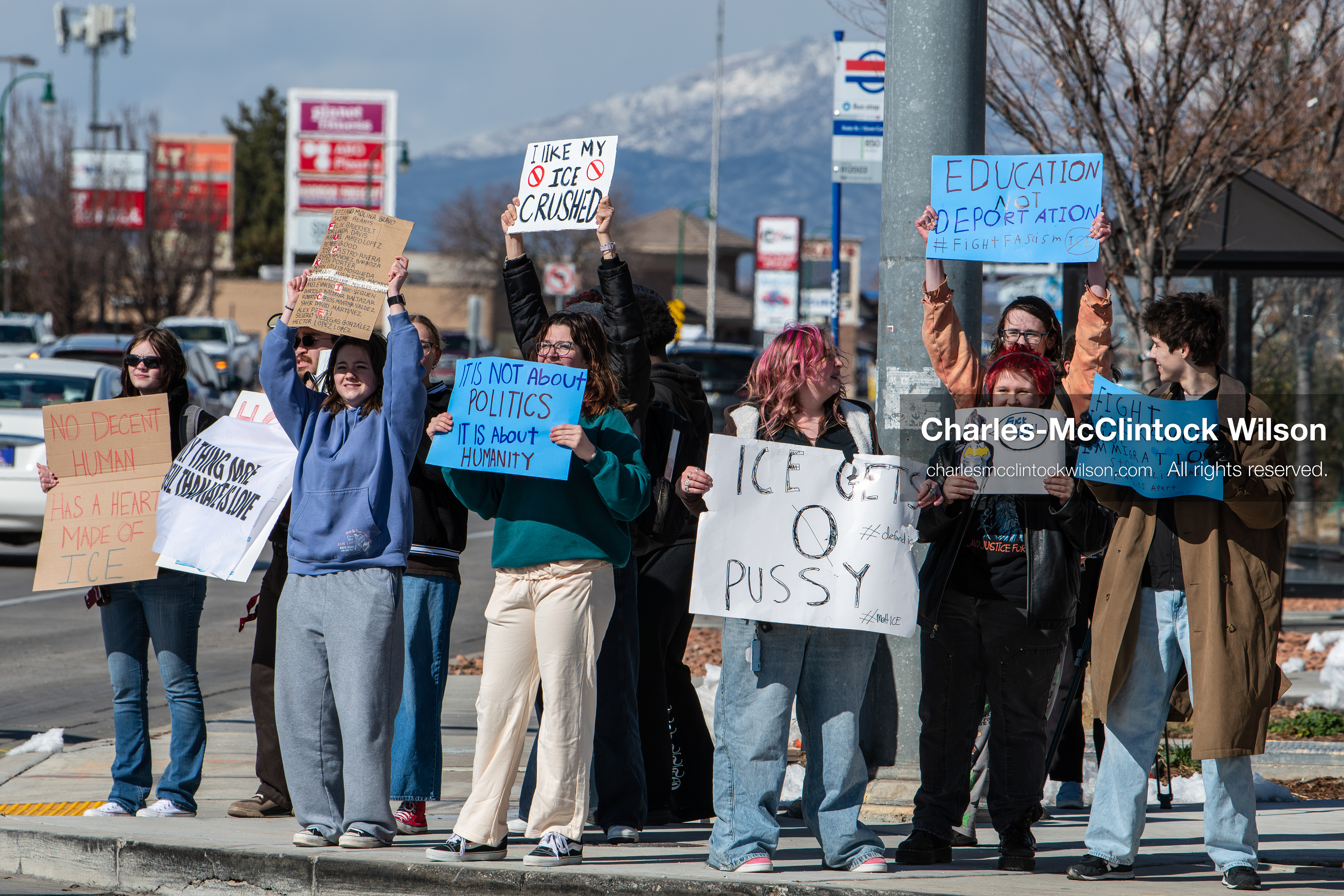 February 20, 2026, Orem, Utah, USA: High school students gather along State Street in front of Orem City Hall during a student led protest against ICE and federal immigration enforcement. Demonstrators hold signs as they stand near the roadway while traffic continues through the area. (Credit Image: © Charles McClintock Wilson/ZUMA Press Wire)