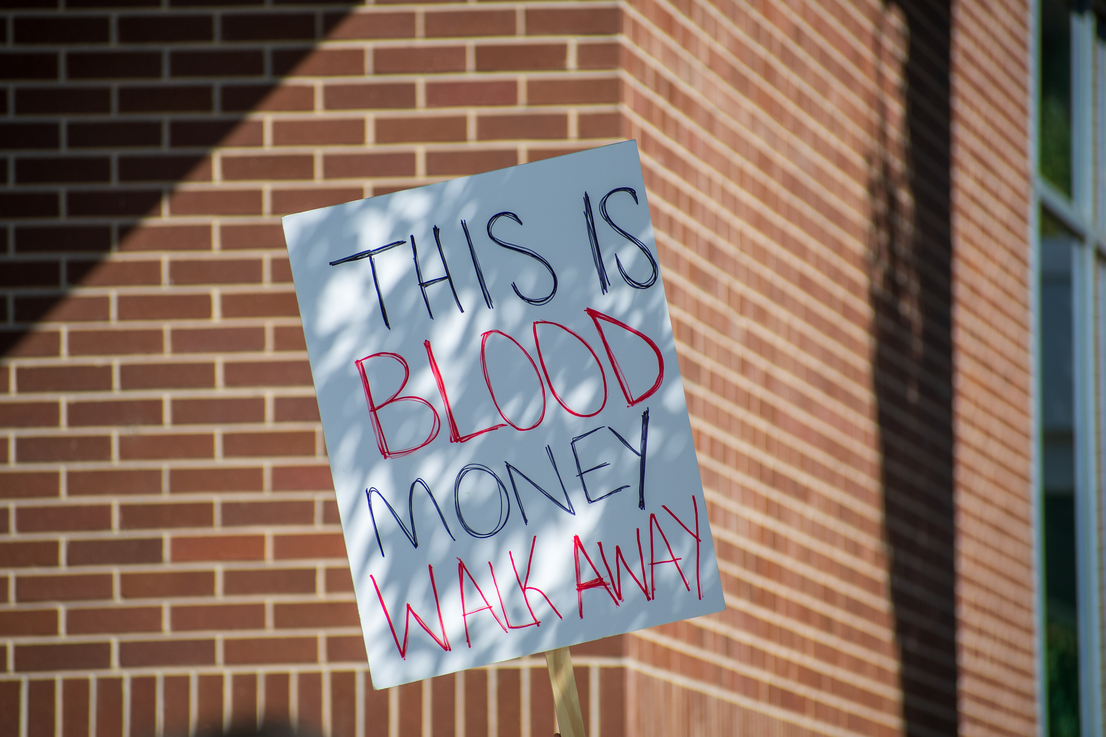 September 15, 2025 – Provo, Utah, United States: A demonstrator holds a sign reading “THIS IS BLOOD MONEY WALK AWAY” outside the Utah Valley Convention Center during a protest against the Department of Homeland Security career expo. The message critiques federal recruitment and calls for moral disengagement. Photograph by Charles‑McClintock Wilson / ZUMA Press Wire