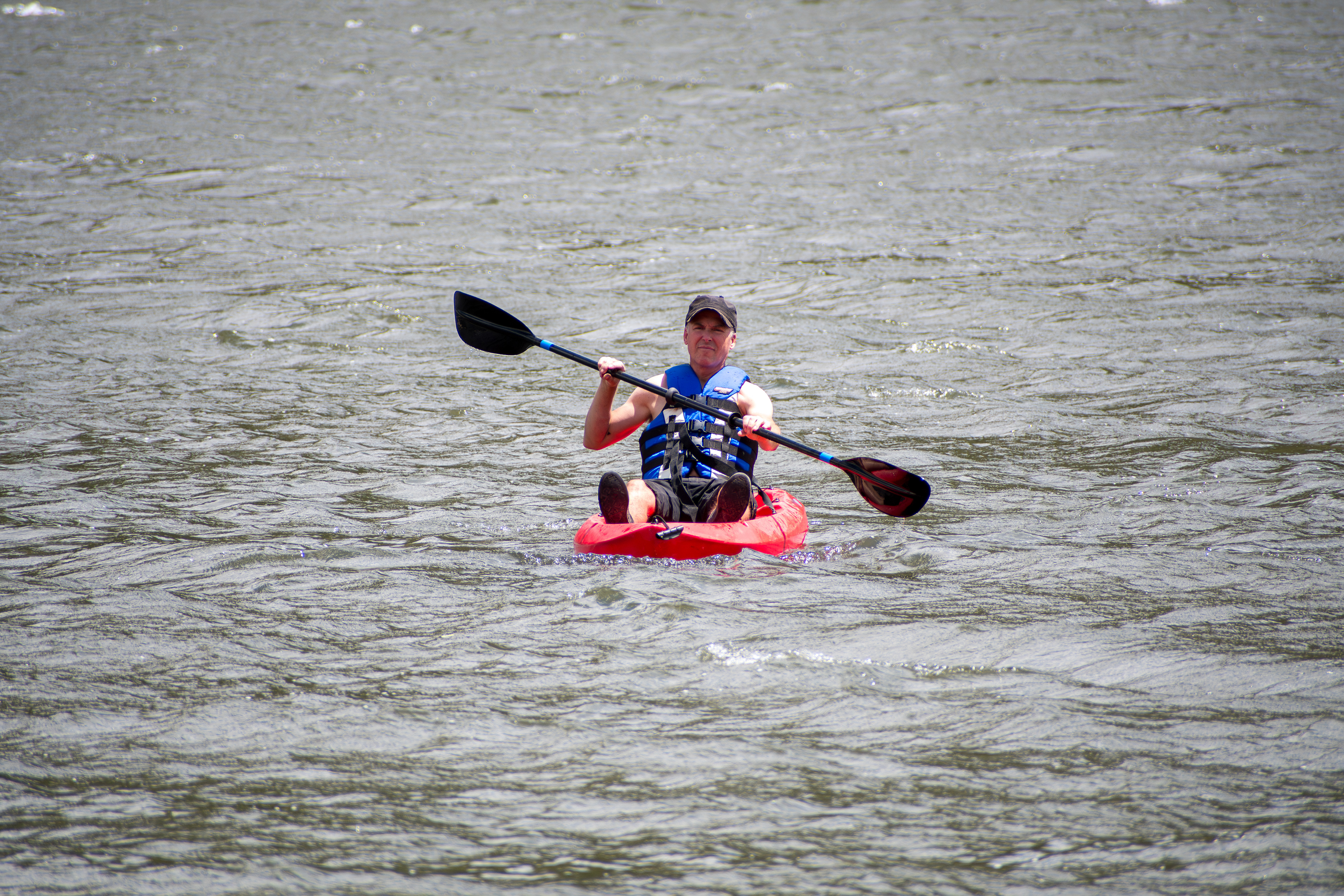 Summit County, Utah – July 20, 2025: A man paddles a kayak across the calm waters of Smith and Morehouse Reservoir during a peaceful summer outing.