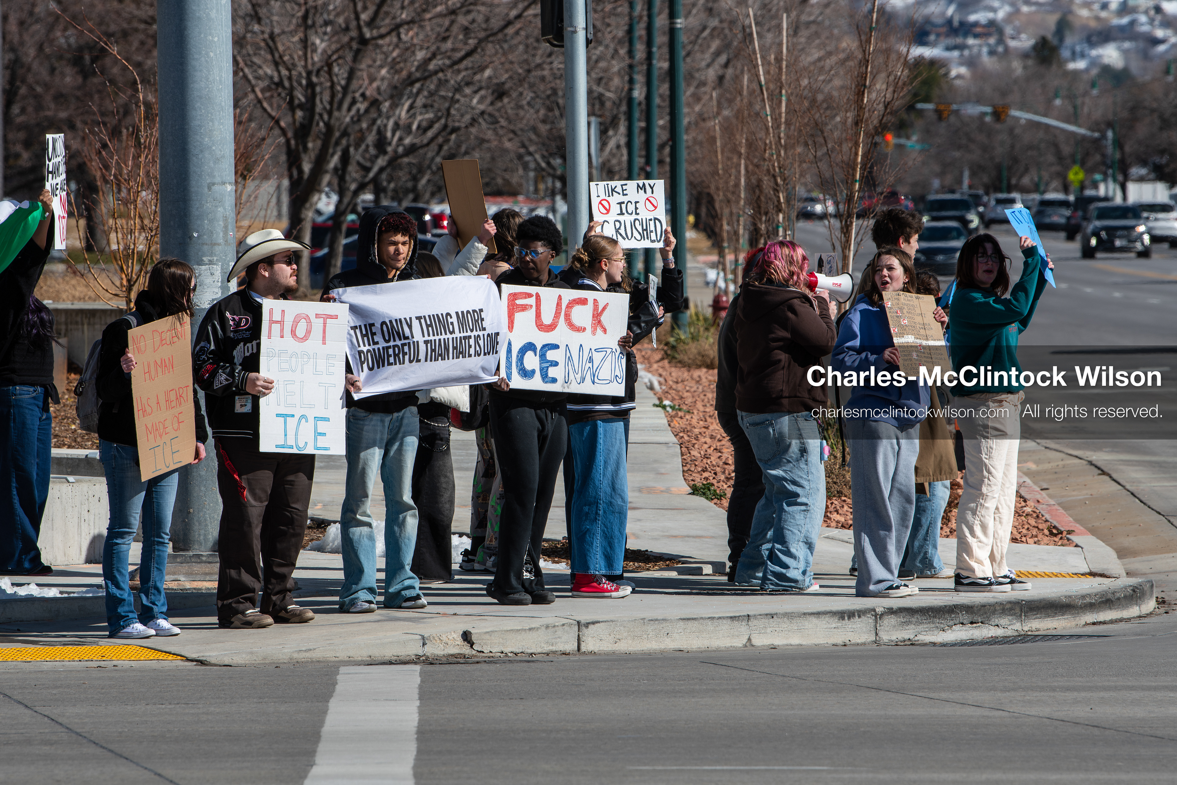 February 20, 2026, Orem, Utah, USA: High school students gather along State Street in front of Orem City Hall during a student led protest against ICE and federal immigration enforcement. Demonstrators hold signs as they stand near the roadway while traffic continues through the area. (Credit Image: © Charles McClintock Wilson/ZUMA Press Wire)