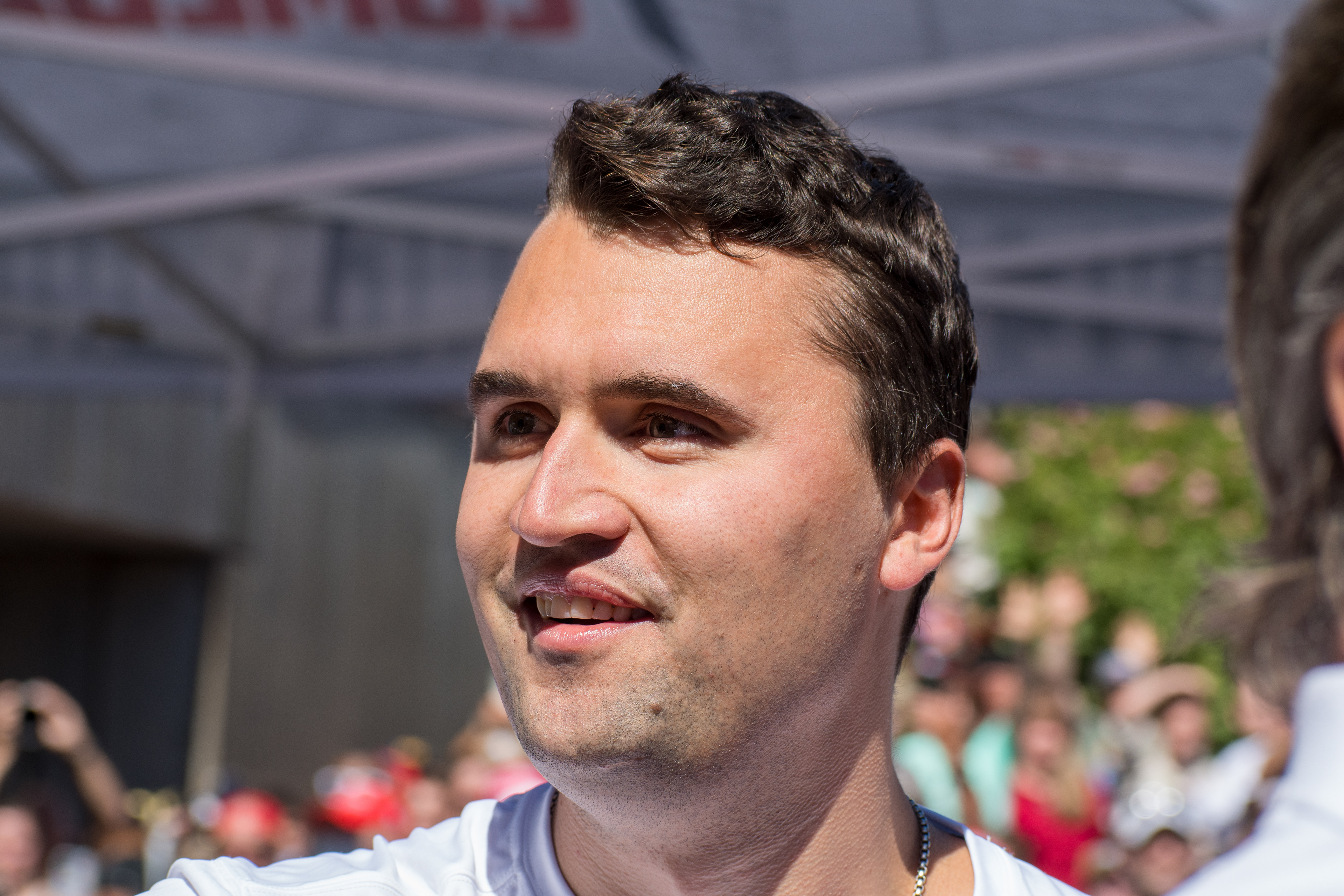 OREM, UTAH – SEPTEMBER 10, 2025: Charlie Kirk speaks with attendees during a public event at Utah Valley University. Positioned near a promotional booth and surrounded by supporters, Kirk appears engaged and expressive in one of his final public moments. The image reflects the atmosphere of direct outreach and energized dialogue that defined the gathering. © Charles-McClintock Wilson / ZUMA Press