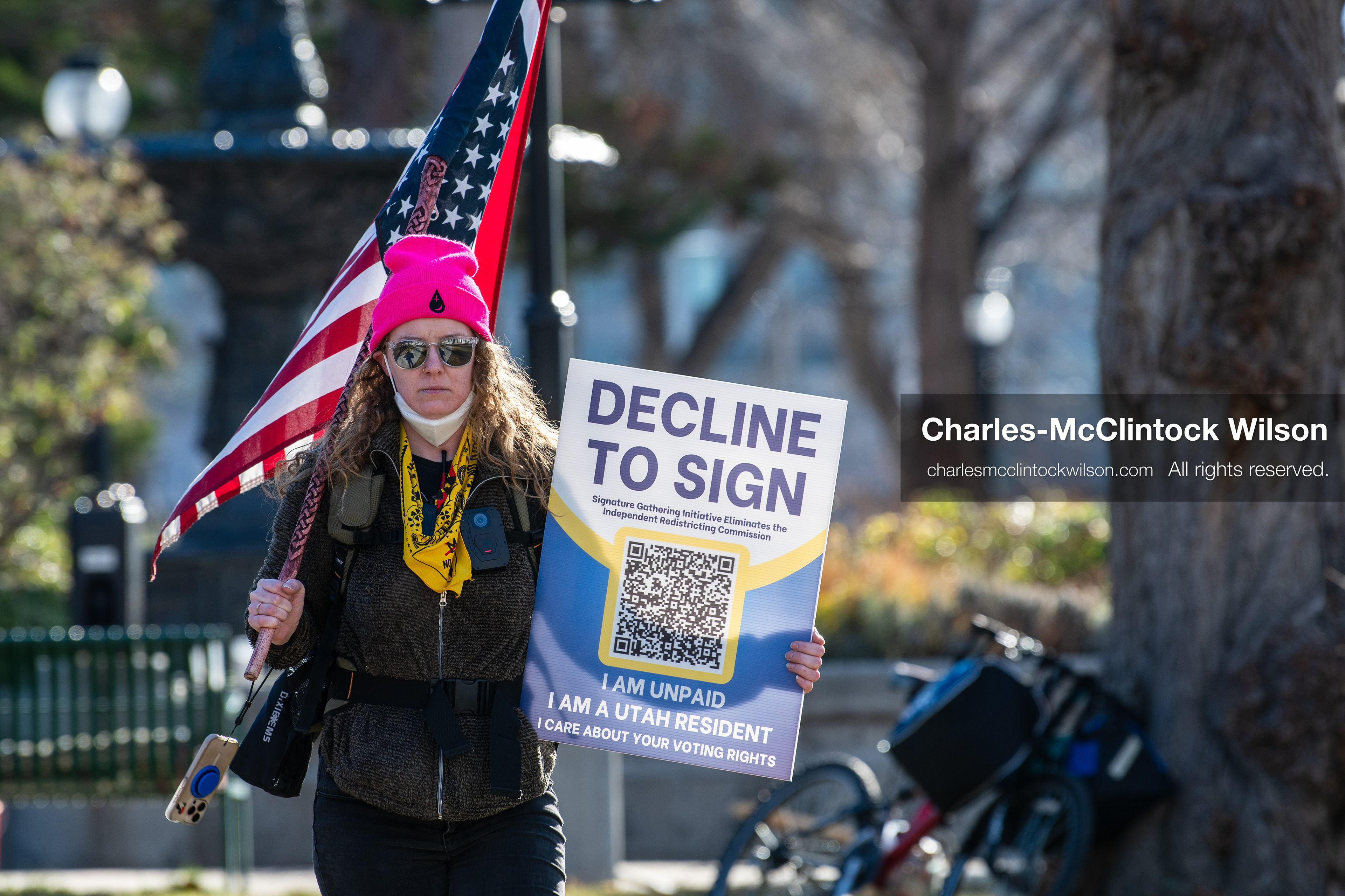 Salt Lake City, Utah, January 10, 2026: A protester holds a sign and an American flag during the ICE Out for Good protest at Washington Square Park. The sign urges Utah residents to decline to sign a petition and affirms support for voting rights. (Credit Image: © Charles‑McClintock Wilson/ZUMA Press Wire)