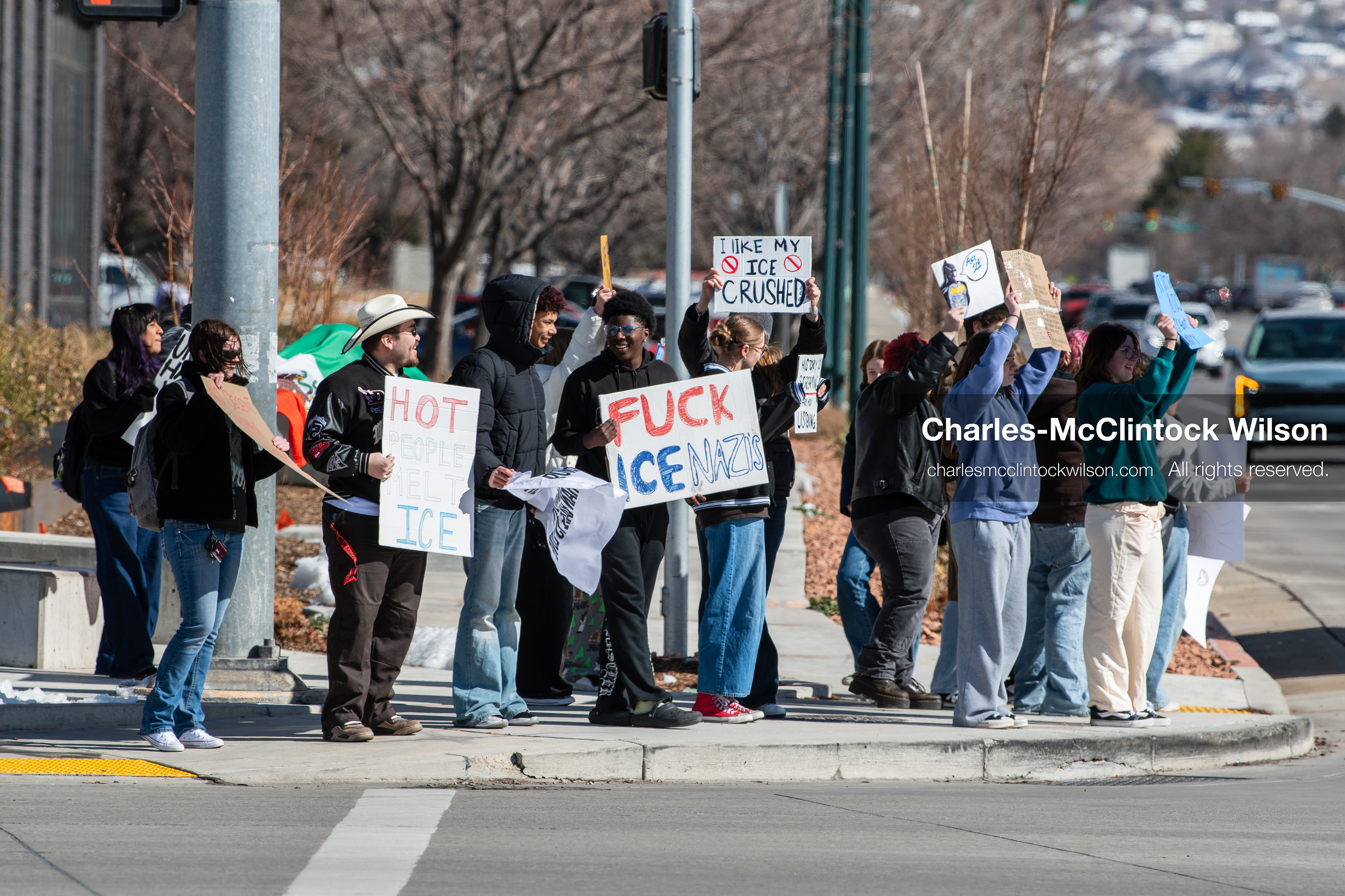February 20, 2026, Orem, Utah, USA: High school students gather along State Street in front of Orem City Hall during a student led protest against ICE and federal immigration enforcement. Demonstrators hold signs as they stand near the roadway while traffic continues through the area. (Credit Image: © Charles McClintock Wilson/ZUMA Press Wire)