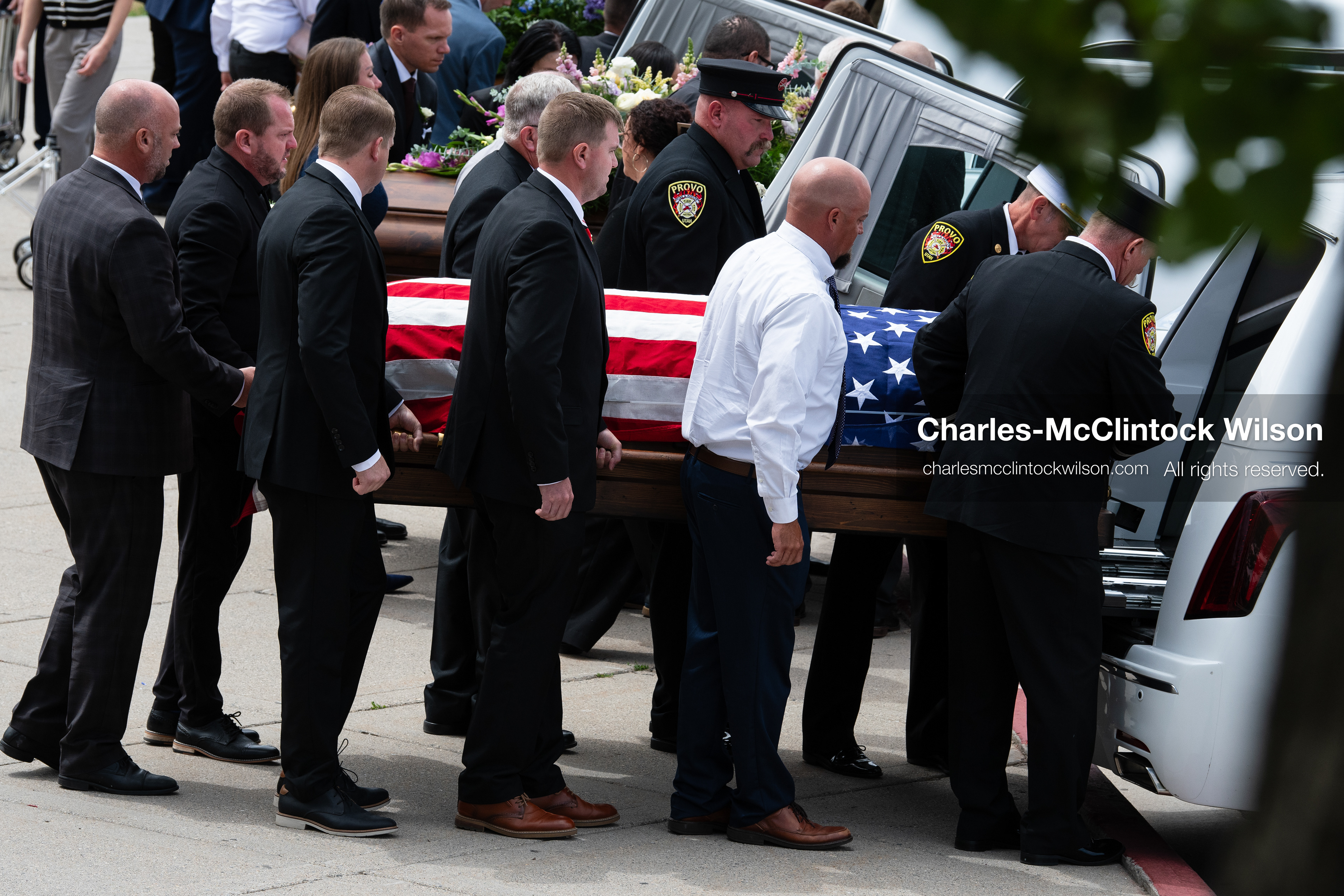 Firefighters and pallbearers load the flag-draped casket of Provo Fire Captain Spencer Long into a white hearse outside the UCCU Center at Utah Valley University in Orem, Utah, on Wednesday, July 29, 2026. More than 300 people came to the public memorial ceremony to honor Captain Long, his wife Katrina, and three of their sons, who died after a flash flood hit their campsite near the Sunglow Campground in Wayne County. (Photo by Charles-McClintock Wilson/Sipa USA)