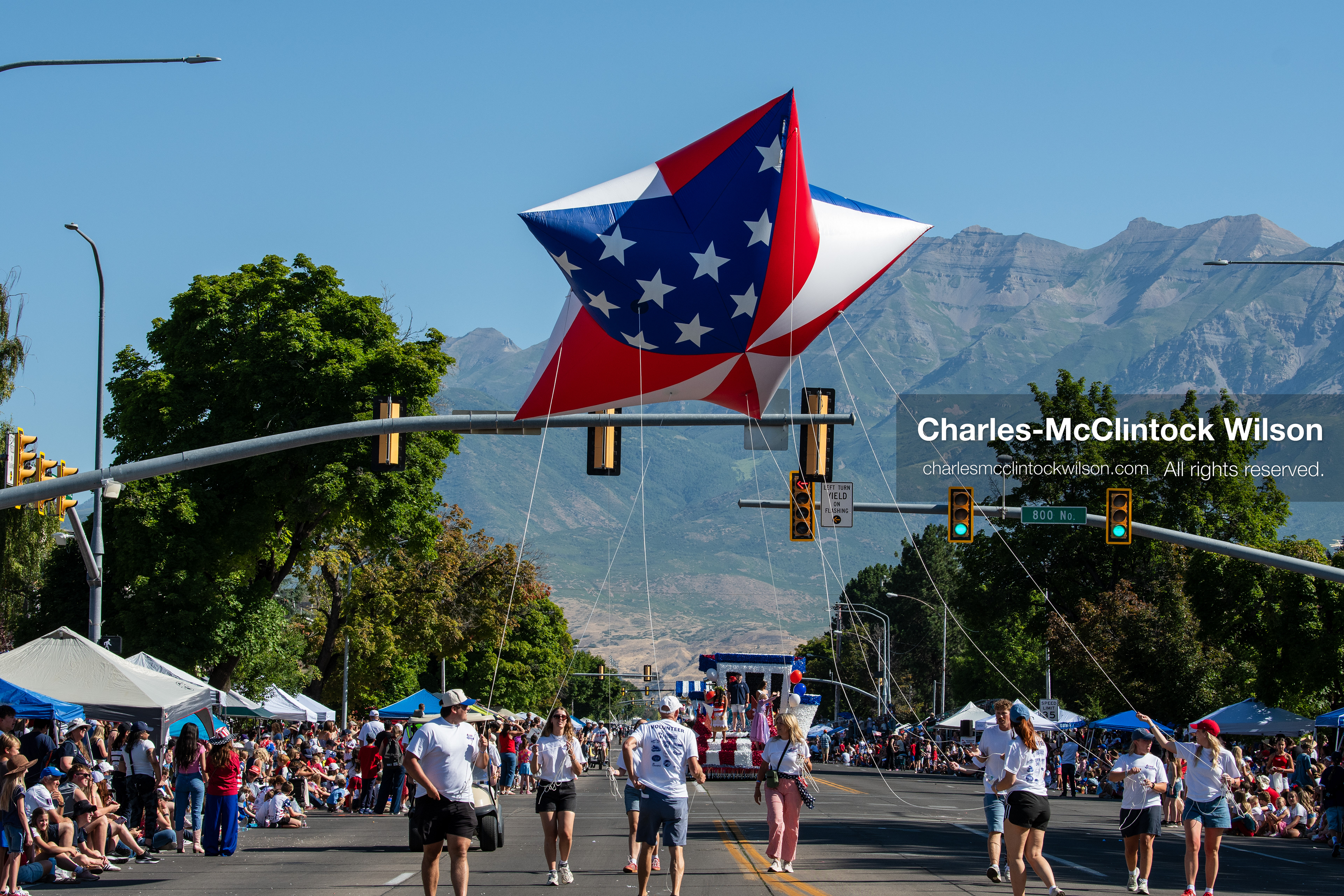 July 4, 2026, Provo, Utah, USA: Handlers guide a giant star-shaped helium balloon decorated with an American flag pattern past crowds during America's Freedom Festival Grand Parade in Provo, Utah, Saturday, July 4, 2026. The annual event drew thousands of spectators to the downtown corridor. (Credit Image: © Charles-McClintock Wilson/ZUMA Press Wire)
