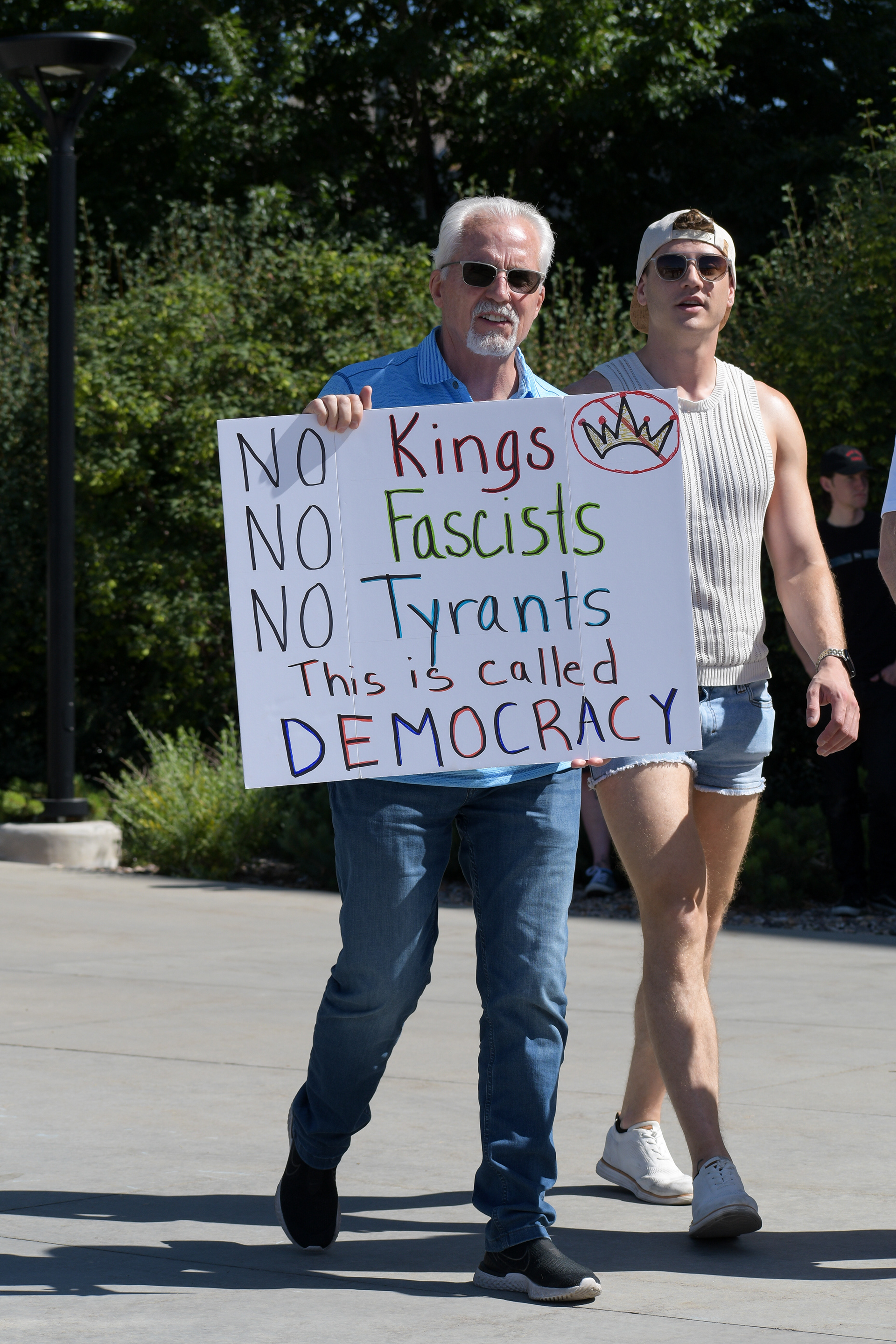SALT LAKE CITY, UTAH – JUNE 15, 2025: Demonstrators march with signs during the “No Kings” protest at the University of Utah, calling for democracy and rejecting authoritarian rule.