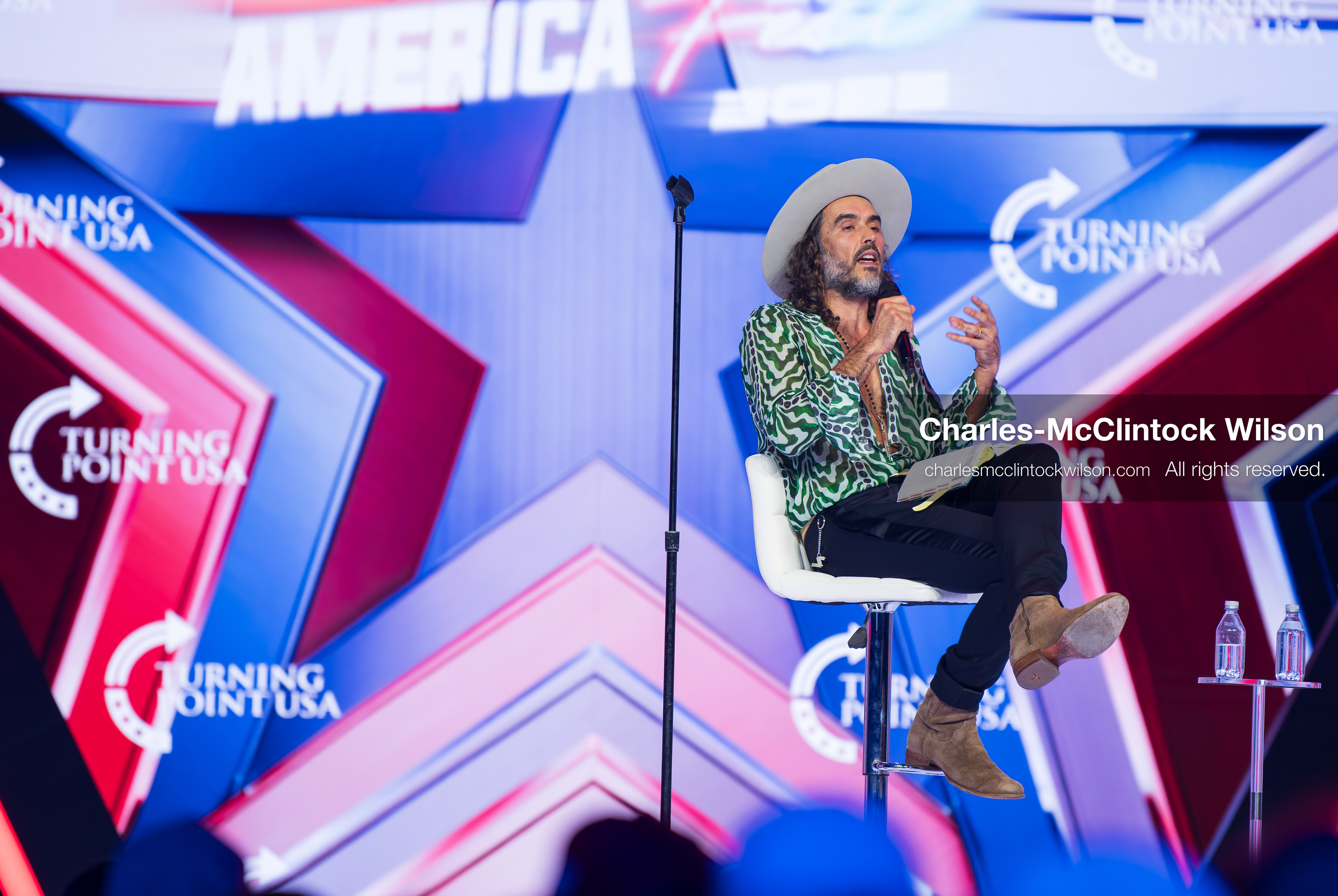 December 18, 2025, Phoenix, Arizona, USA: Russell Brand speaks during Day One of Turning Point USA’s AmericaFest 2025 at the Phoenix Convention Center in Phoenix, Arizona.   (Credit Image: © Charles‑McClintock Wilson/ZUMA Press Wire)