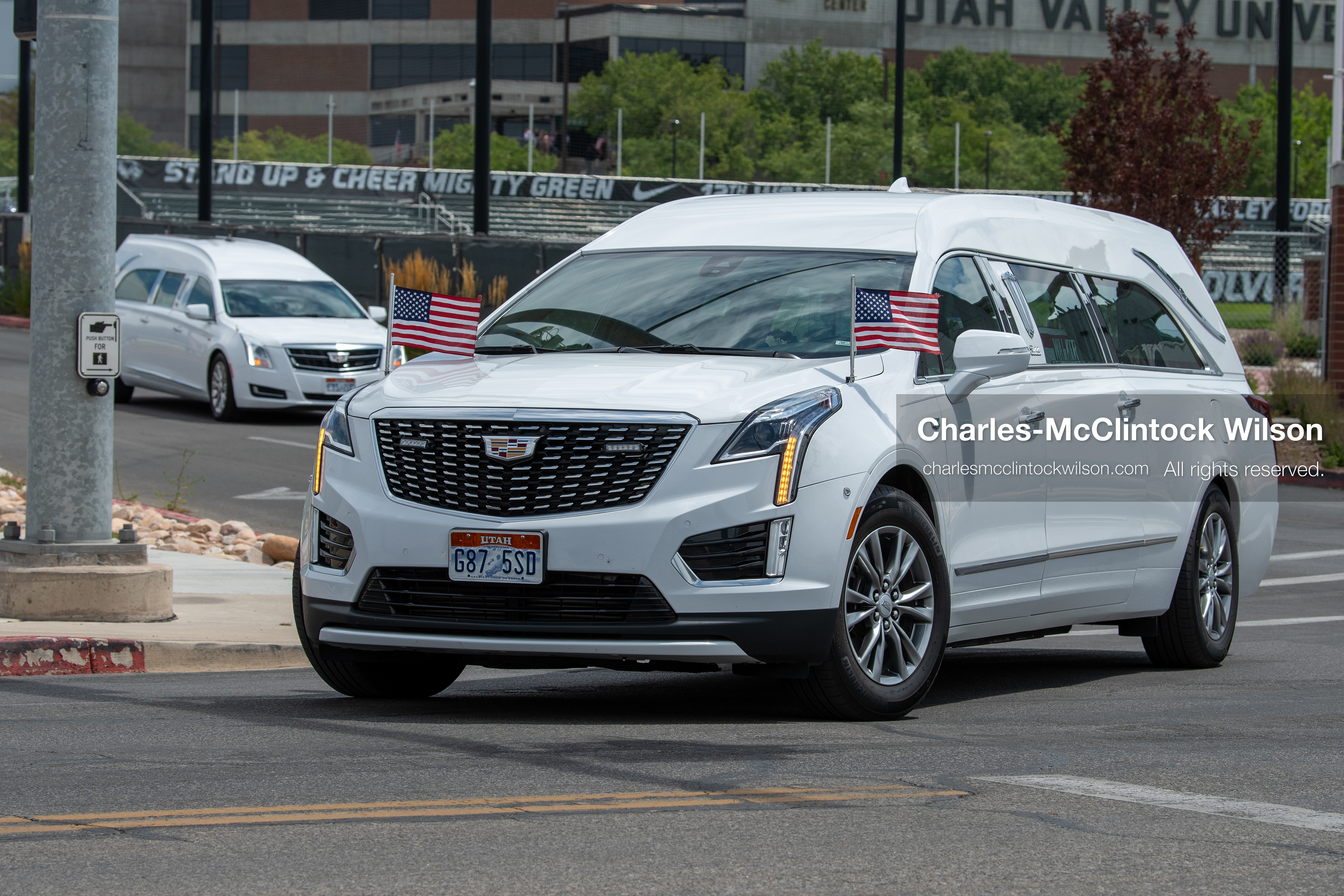 A white Cadillac hearse leads a vehicle procession down the street away from the UCCU Center at Utah Valley University in Orem, Utah, on Wednesday, July 29, 2026. More than 300 people came to the public memorial ceremony to honor Provo Fire Captain Spencer Long, his wife Katrina, and three of their sons, who died after a flash flood hit their campsite near the Sunglow Campground in Wayne County.(Photo by Charles-McClintock Wilson/Sipa USA)
