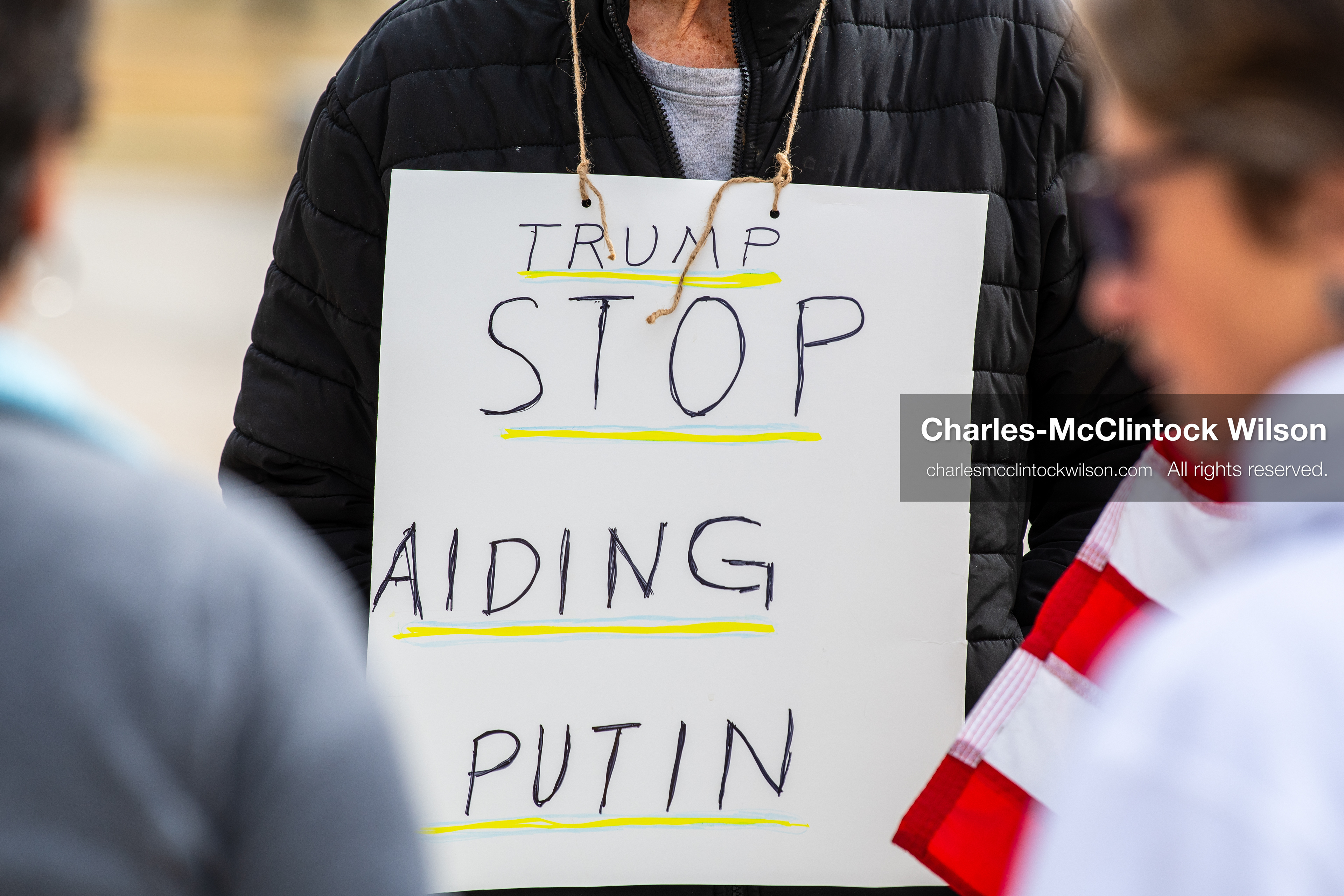 February 28, 2026, Salt Lake City, Utah, USA: A demonstrator wears a sign reading Trump Stop Aiding Putin during the Stand With Ukraine rally at the Utah State Capitol. The gathering marked the four year anniversary of the full scale Russian invasion of Ukraine and brought community members together in support of Ukrainians and local humanitarian efforts. (Credit Image: © Charles McClintock Wilson/ZUMA Press Wire)