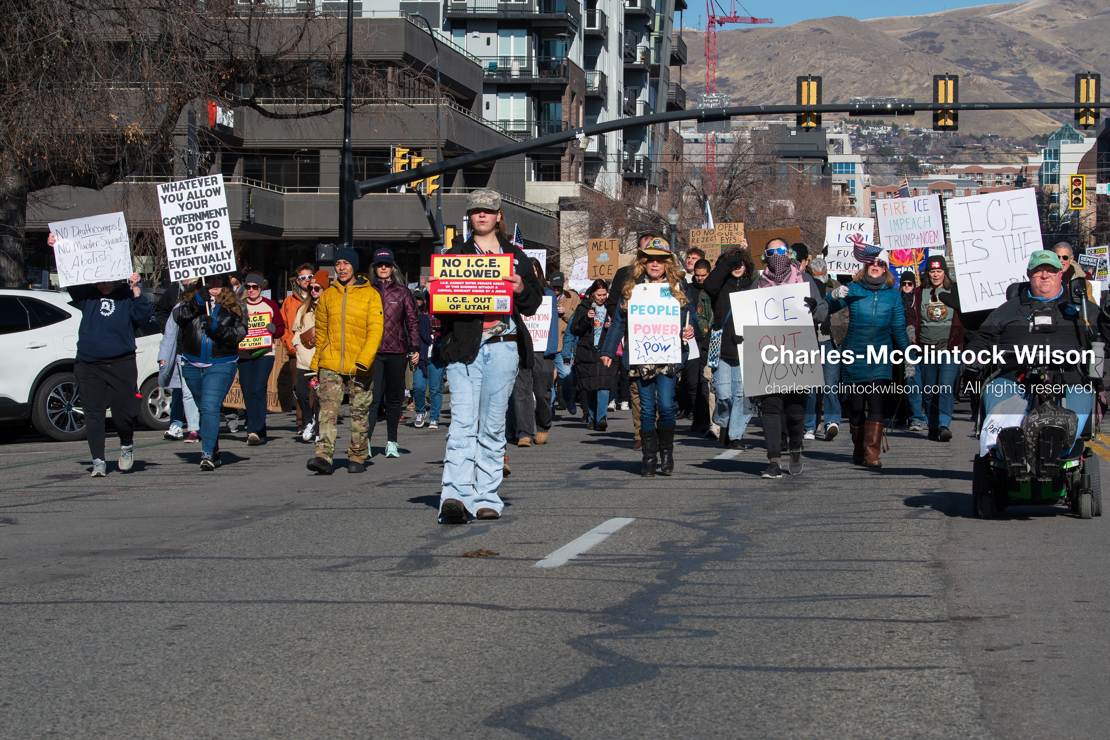 Salt Lake City, Utah, January 10, 2026: A group of demonstrators marches through downtown Salt Lake City during the ICE Out for Good protest, which began at Washington Square Park, with participants carrying signs and personal items as they walk together. (Credit Image: © Charles‑McClintock Wilson/ZUMA Press Wire)