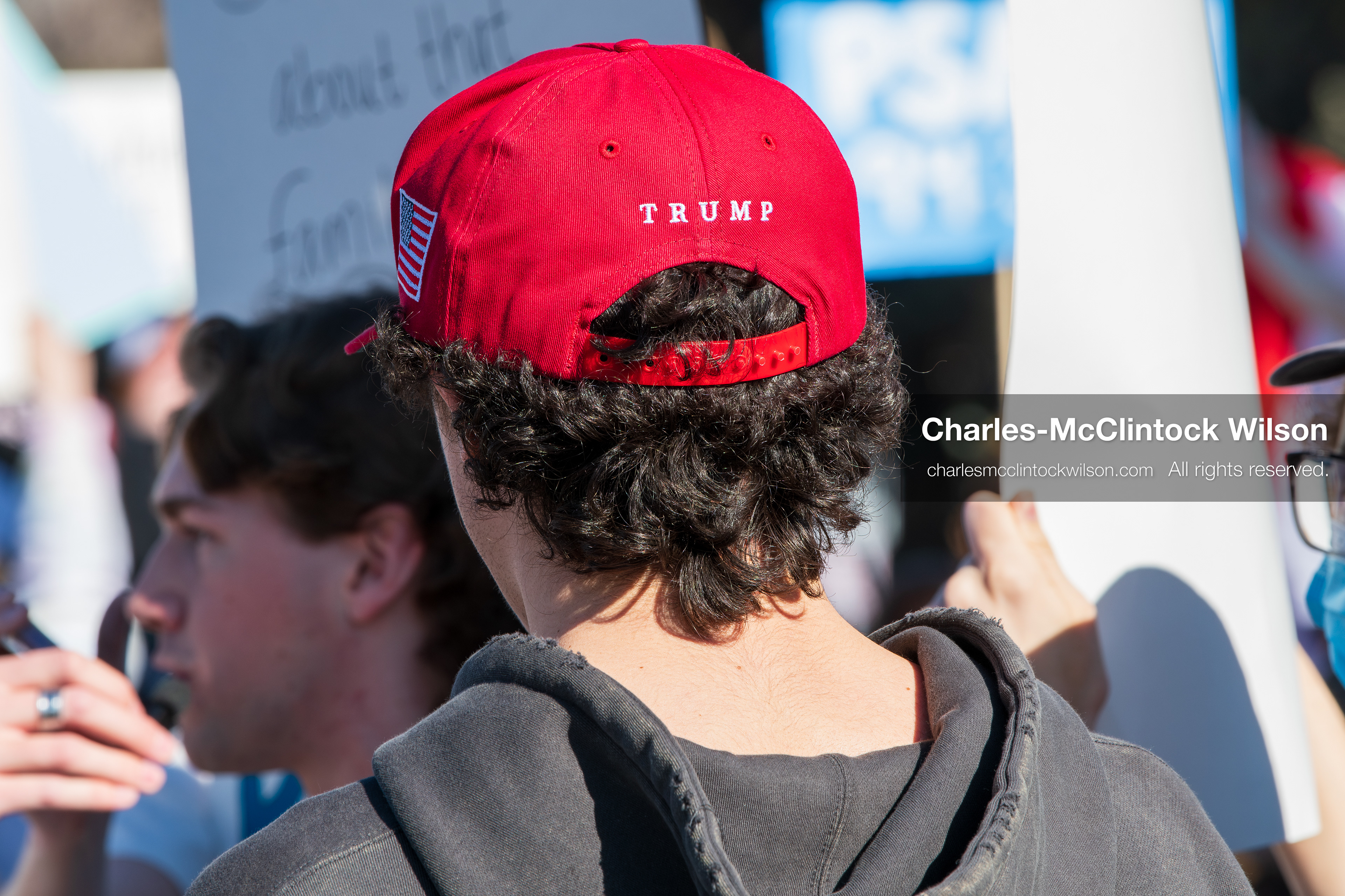 February 5, 2026, Provo, Utah, USA: A person wearing a red Make America Great Again hat stands among demonstrators near Brigham Young University in Provo during a gathering opposing the presence of US Customs and Border Protection recruiters at a career fair held on the BYU campus. (Credit Image: © Charles McClintock Wilson/ZUMA Press Wire)