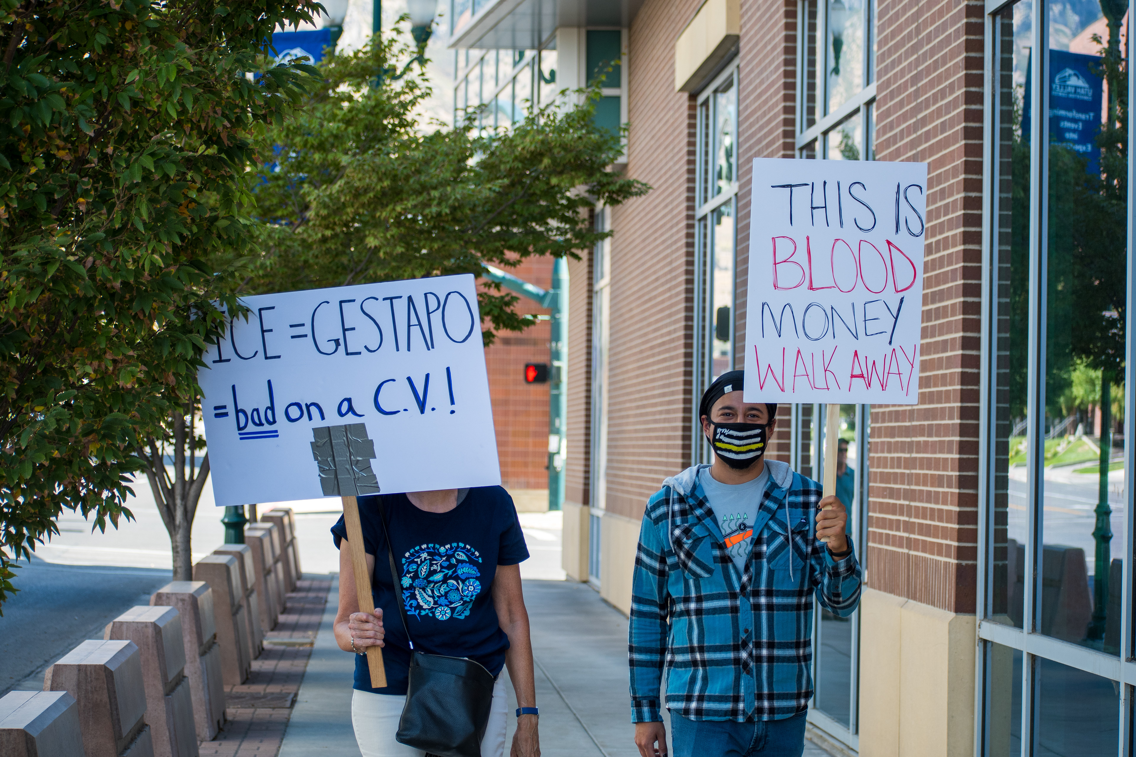 September 15, 2025 – Provo, Utah, United States: Demonstrators hold signs outside the Utah Valley Convention Center during a protest against the Department of Homeland Security career expo, voicing opposition to federal policing and immigration enforcement. Photograph by Charles‑McClintock Wilson / ZUMA Press Wire