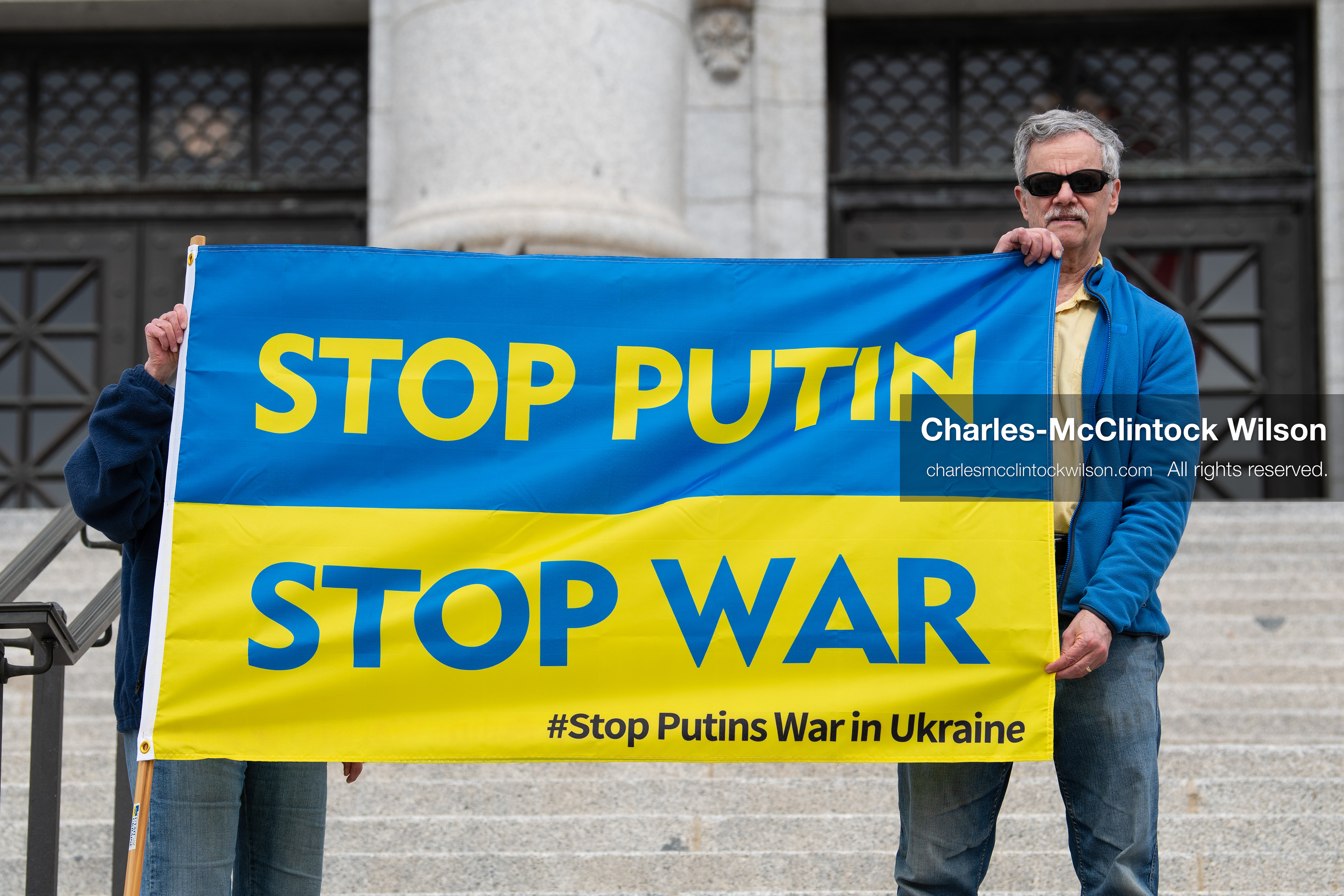 February 28, 2026, Salt Lake City, Utah, USA: Demonstrators hold a large blue and yellow banner resembling the Ukrainian flag with the words Stop Putin Stop War during the Stand With Ukraine rally at the Utah State Capitol. The gathering marked the four year anniversary of the full scale Russian invasion of Ukraine and brought community members together in support of Ukrainians and local humanitarian efforts. (Credit Image: © Charles McClintock Wilson/ZUMA Press Wire)