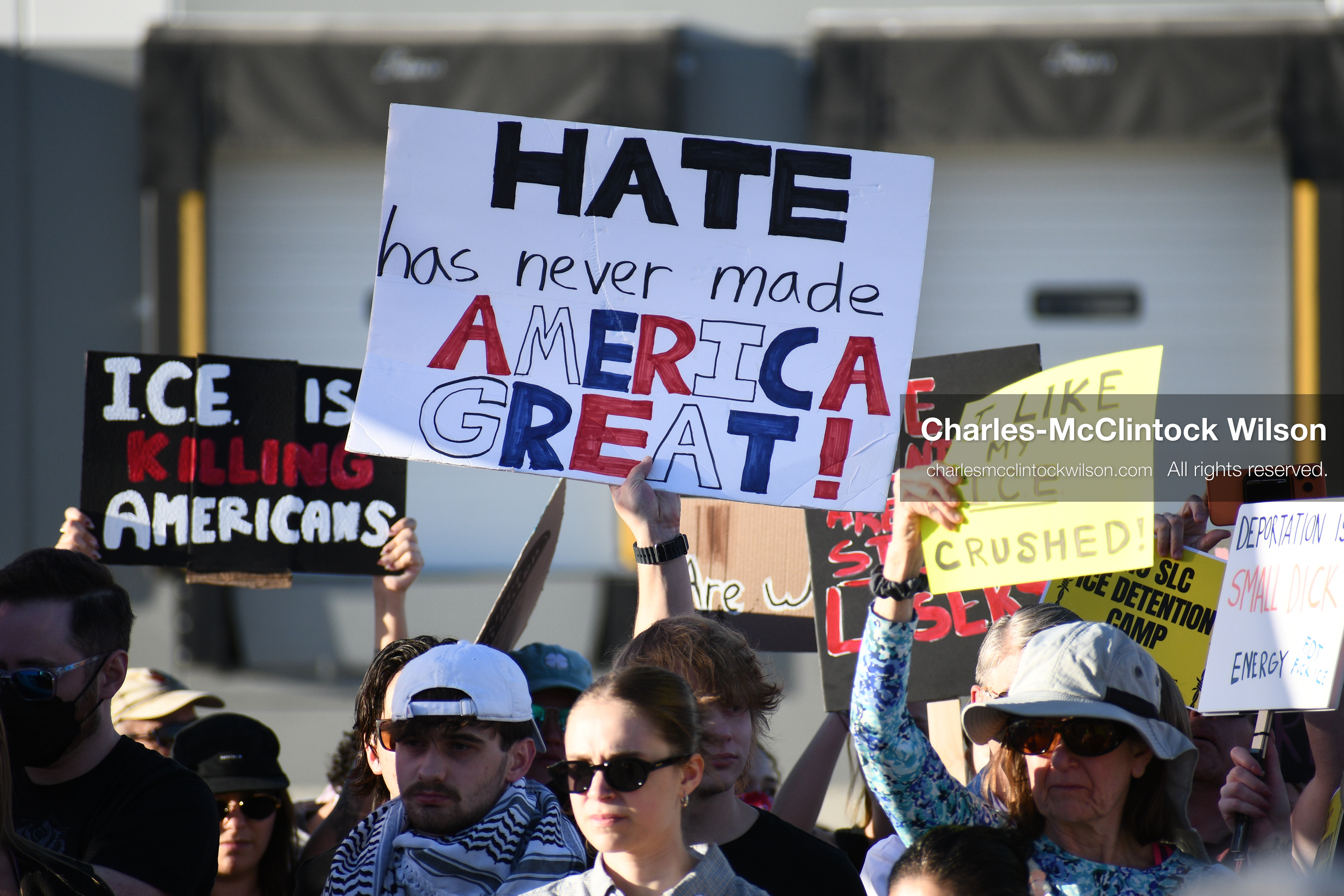 March 18, 2026, Salt Lake City, Utah, USA: People hold signs during a protest at the site of a proposed ICE detention facility on the west side of Salt Lake City. Demonstrators gathered near the warehouse property as part of an ongoing community response to the planned facility. (Credit Image: © Charles McClintock Wilson/ZUMA Press Wire)