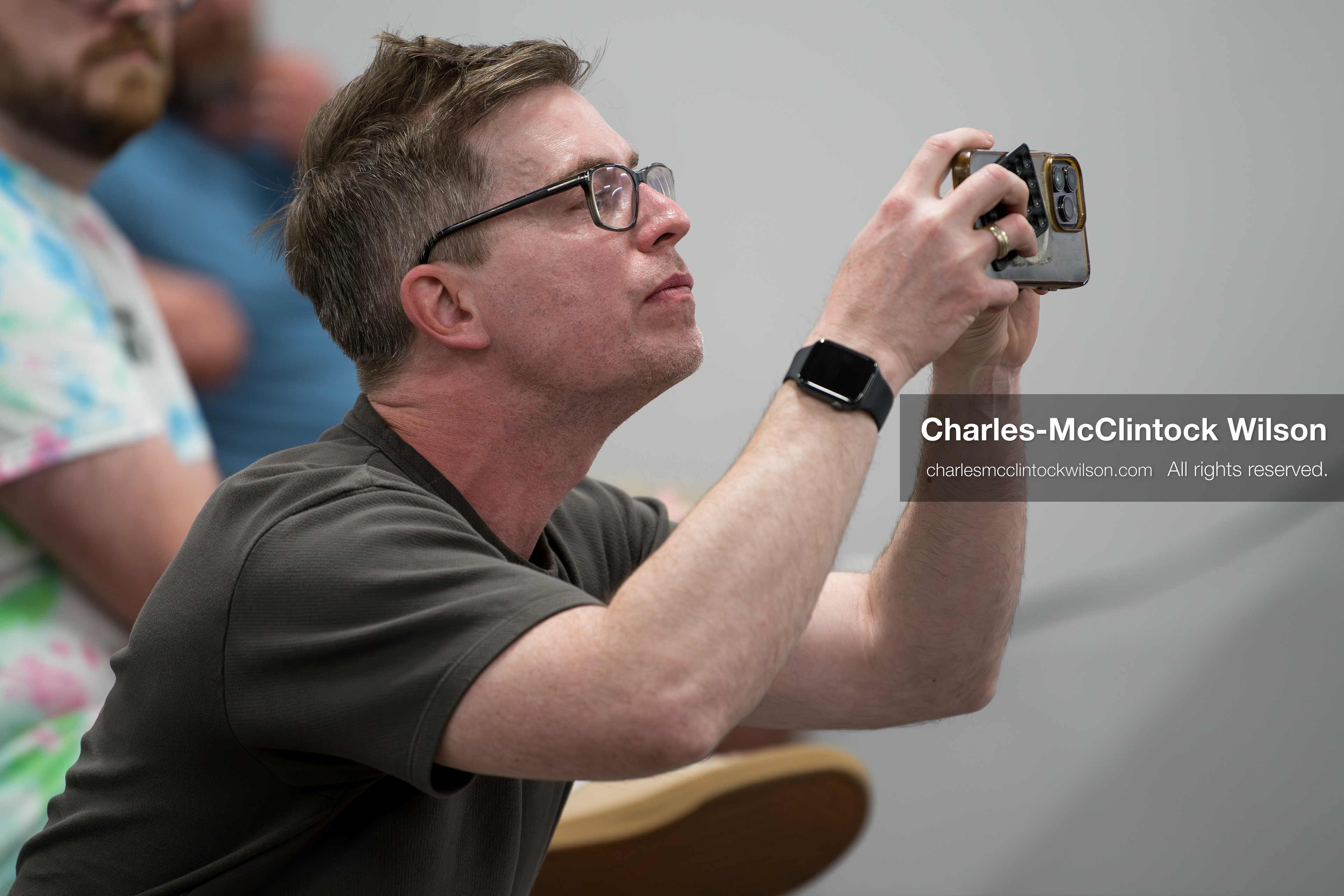 May 13, 2026, Brigham City, Utah, USA: US political satirist and digital creator WALTER MASTERSON records video on his phone inside the Box Elder County Justice Center in Brigham City, Utah, during a public meeting over the proposed data‑center project backed by businessman Kevin O’Leary, which has drawn public concern over water use, power demand, and transparency. (Credit Image: © Charles‑McClintock Wilson/ZUMA Press Wire)