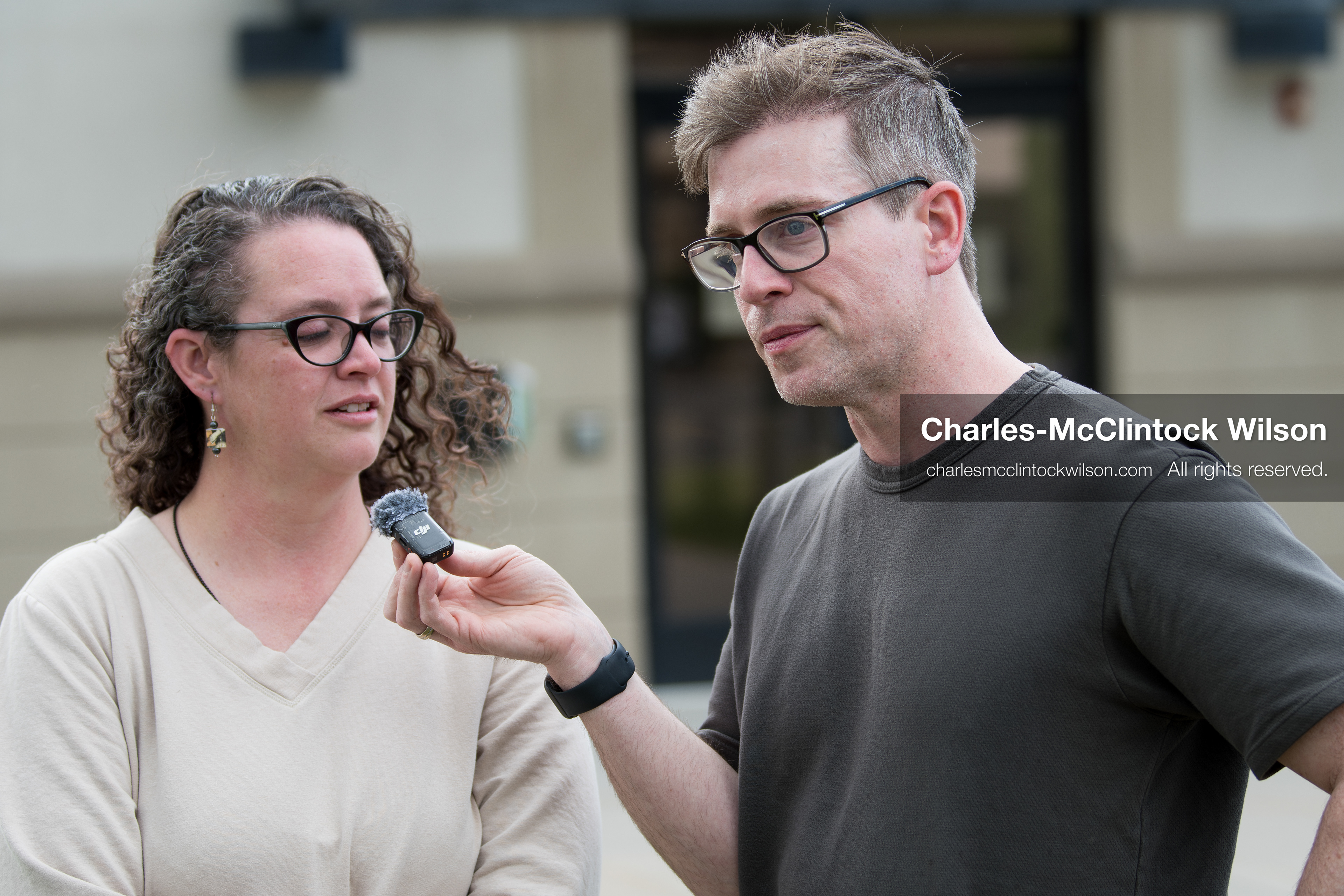 May 13, 2026, Brigham City, Utah, USA: US political satirist and digital creator WALTER MASTERSON interviews a woman outside the Box Elder County Justice Courthouse in Brigham City, Utah, during a gathering over the proposed data‑center project backed by businessman Kevin O’Leary, which has drawn public concern over water use, power demand, and transparency. (Credit Image: © Charles‑McClintock Wilson/ZUMA Press Wire)
