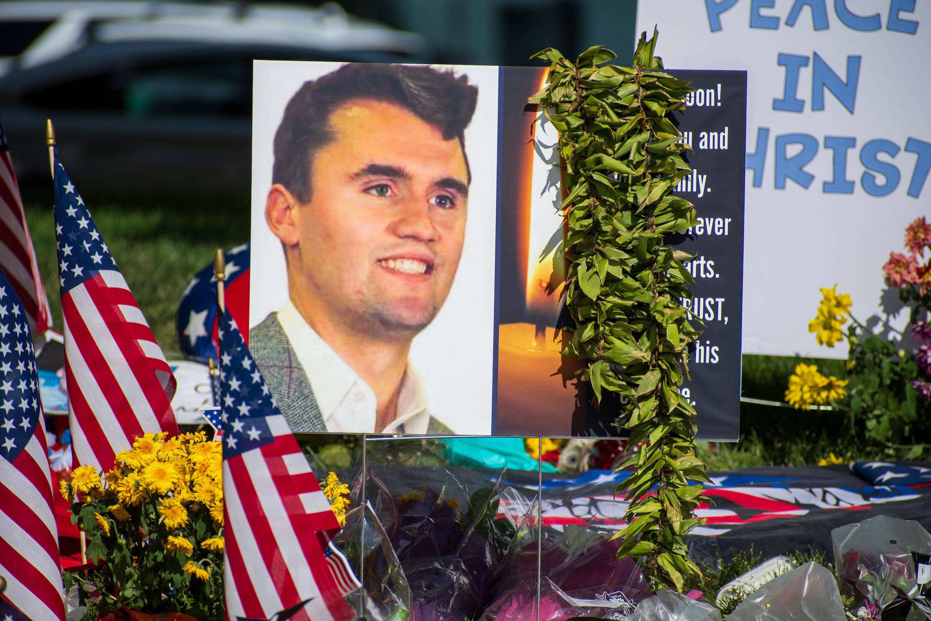 OREM, UTAH – SEPTEMBER 15, 2025: A memorial honoring Charlie Kirk is seen on the campus of Utah Valley University, featuring American flags, candles, flowers, and handwritten signs arranged around a large portrait. The tribute appeared days after Kirk’s final public event at the university. © Charles‑McClintock Wilson / ZUMA Press