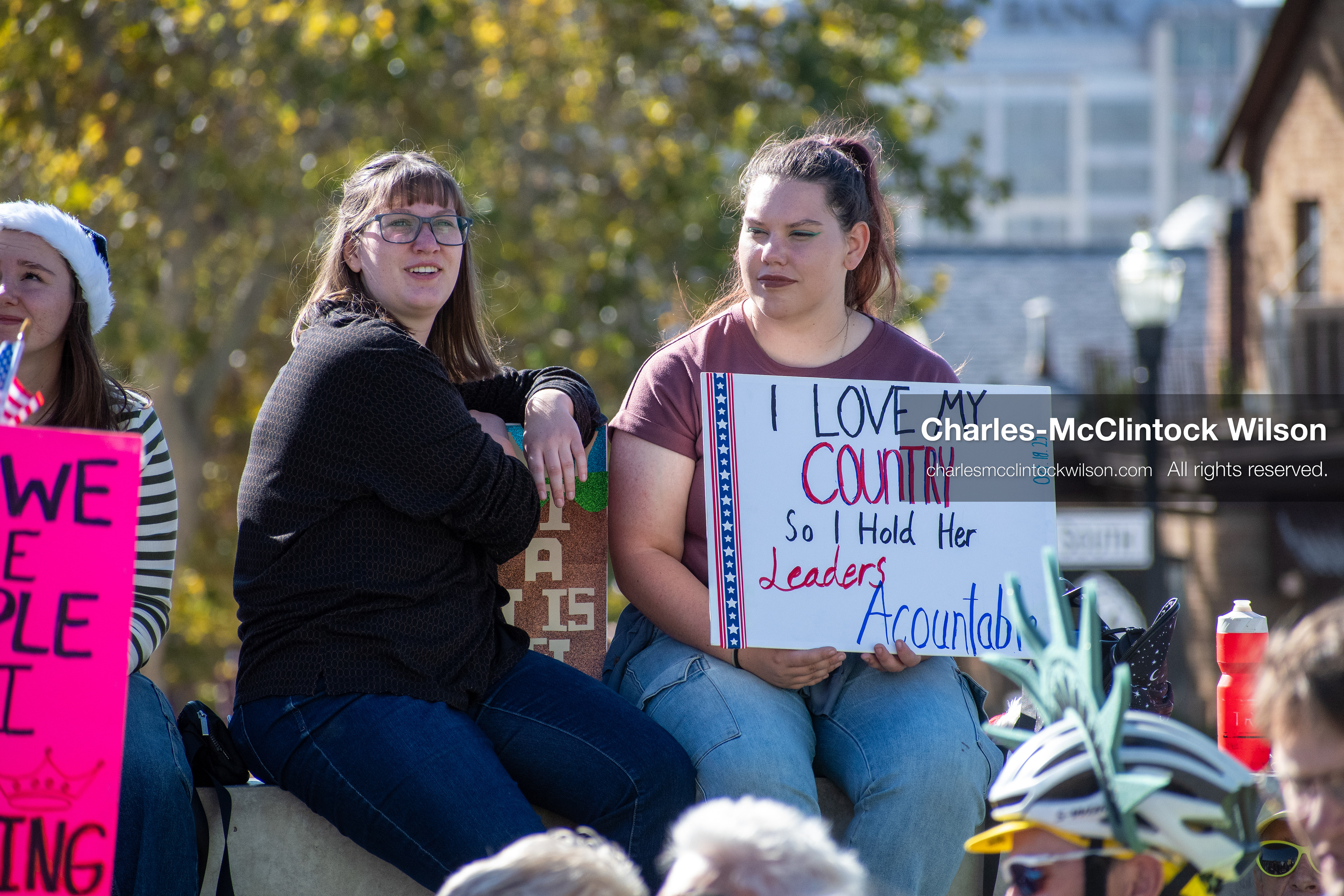 October 18, 2025, Salt Lake City, Utah, USA: Demonstrators sit on a stone ledge during a "No Kings" protest at the Utah State Capitol. The protest was part of a nationwide mobilization.