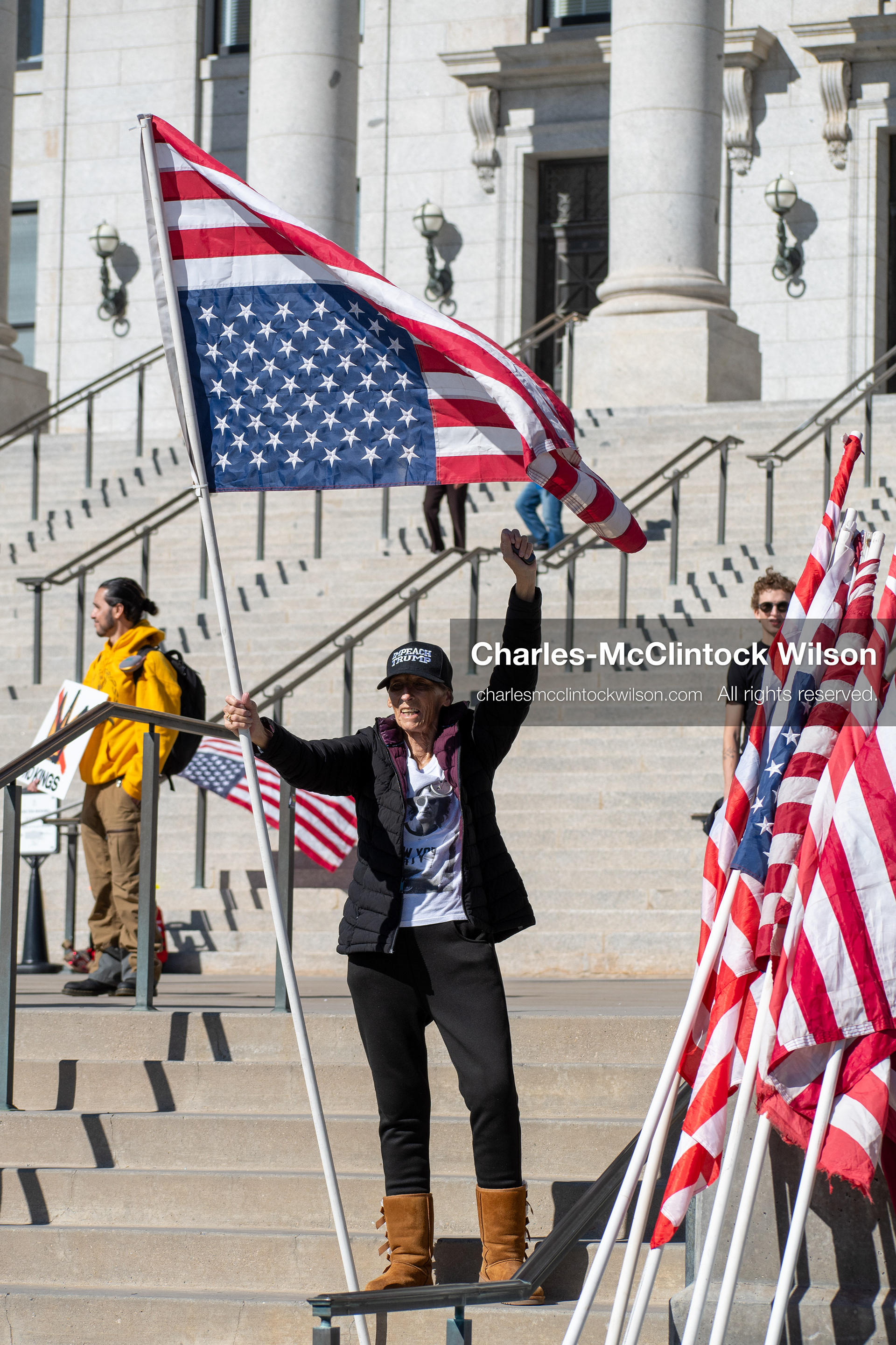 October 18, 2025, Salt Lake City, Utah, USA: A demonstrator stands with an altered American flag during a "No Kings" protest at the Utah State Capitol in Salt Lake City, Utah. The protest was part of a nationwide mobilization.